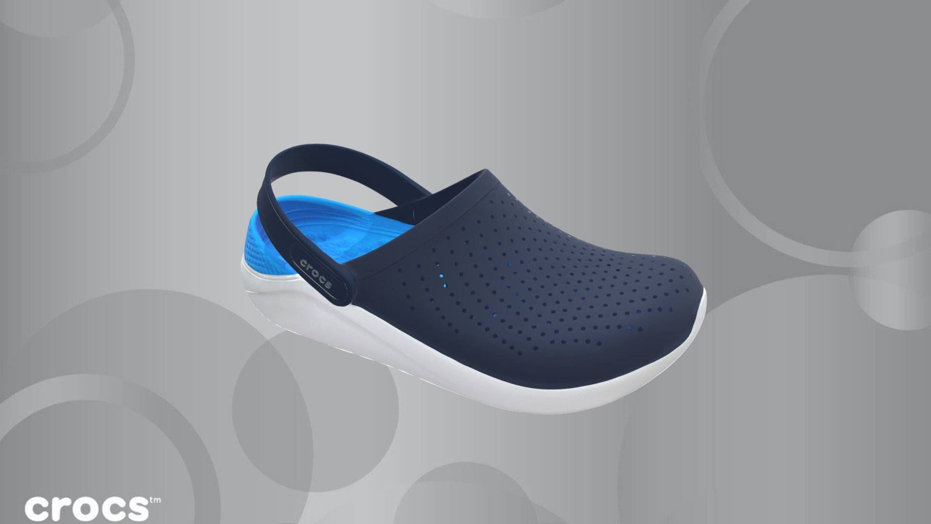 Crocs 桌布 壁紙 — 海軍藍色 Crocs 木屐，內部亮藍色，白色鞋底，漂浮在帶有圓形圖案的灰色背景上。