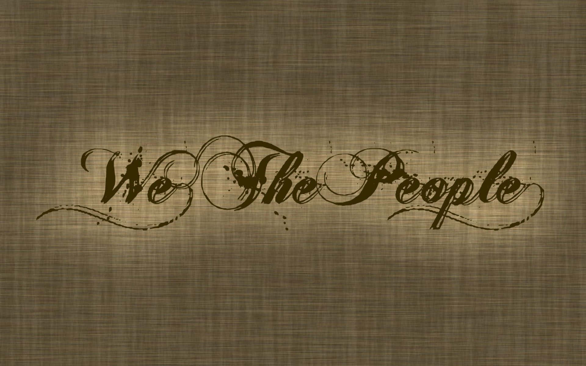 灰色美學動圖 桌布 壁紙 — 深棕色優雅草書文字 'We The People' 在帶有紋理的米色布料背景上。