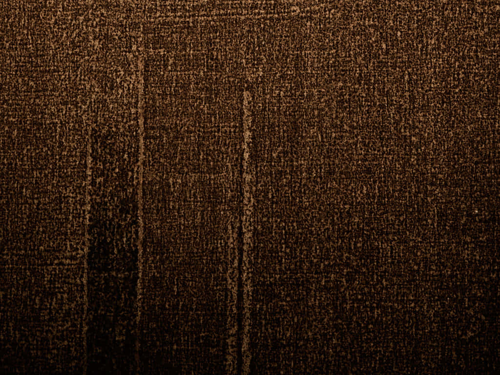 Dark Brown 桌布 壁紙 — 深棕色紋理布料特寫，帶有細微垂直縫線和溫暖金色亮點。