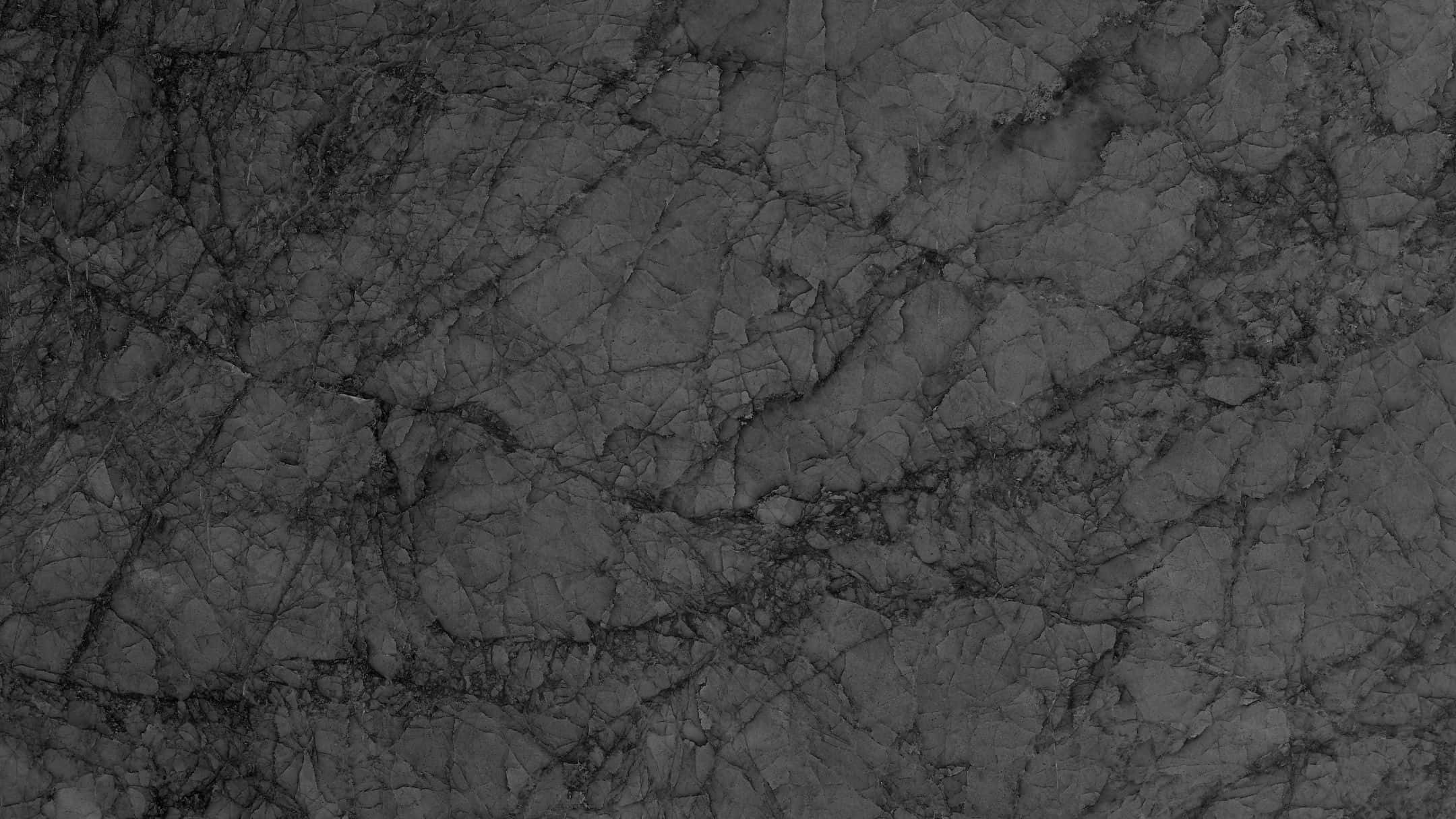 Grey Marble 桌布 壁紙 — 深灰色大理石的近距離特寫，帶有複雜的漩渦紋理和微妙的質感變化。