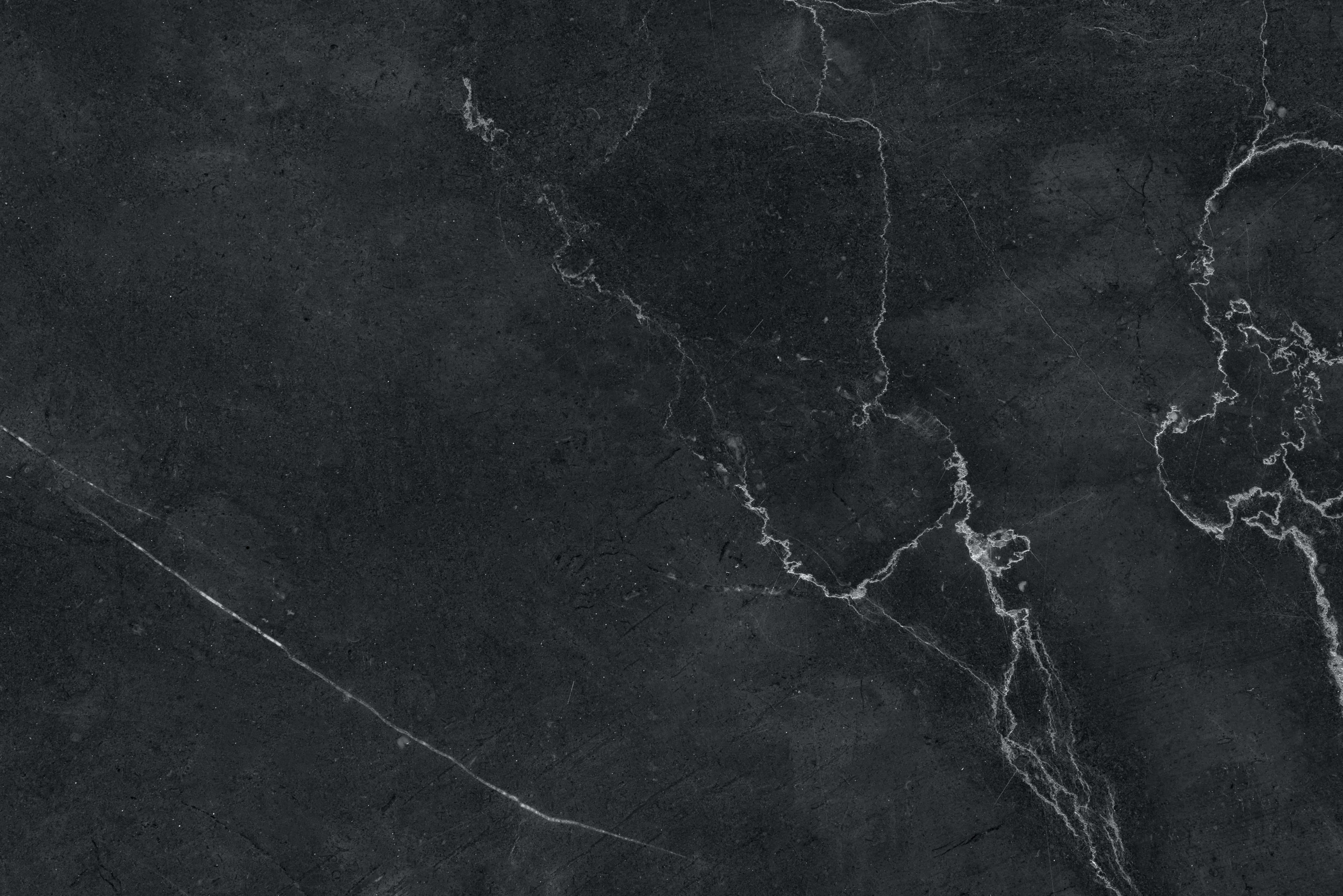 Black And White Marble 桌布 壁紙 — 深灰色大理石的近距離特寫，帶有複雜的白色紋理，營造出奢華精緻的質感。