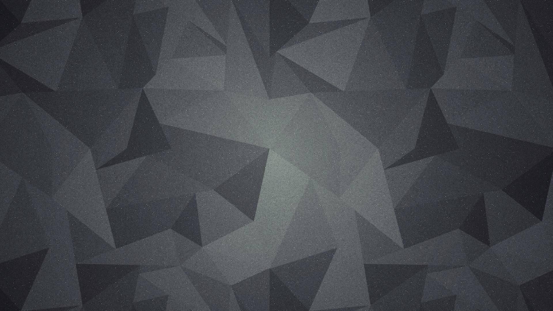 Static 桌布 壁紙 — 深灰色抽象壁紙，帶有幾何三角形切面和柔和的光線漸變。