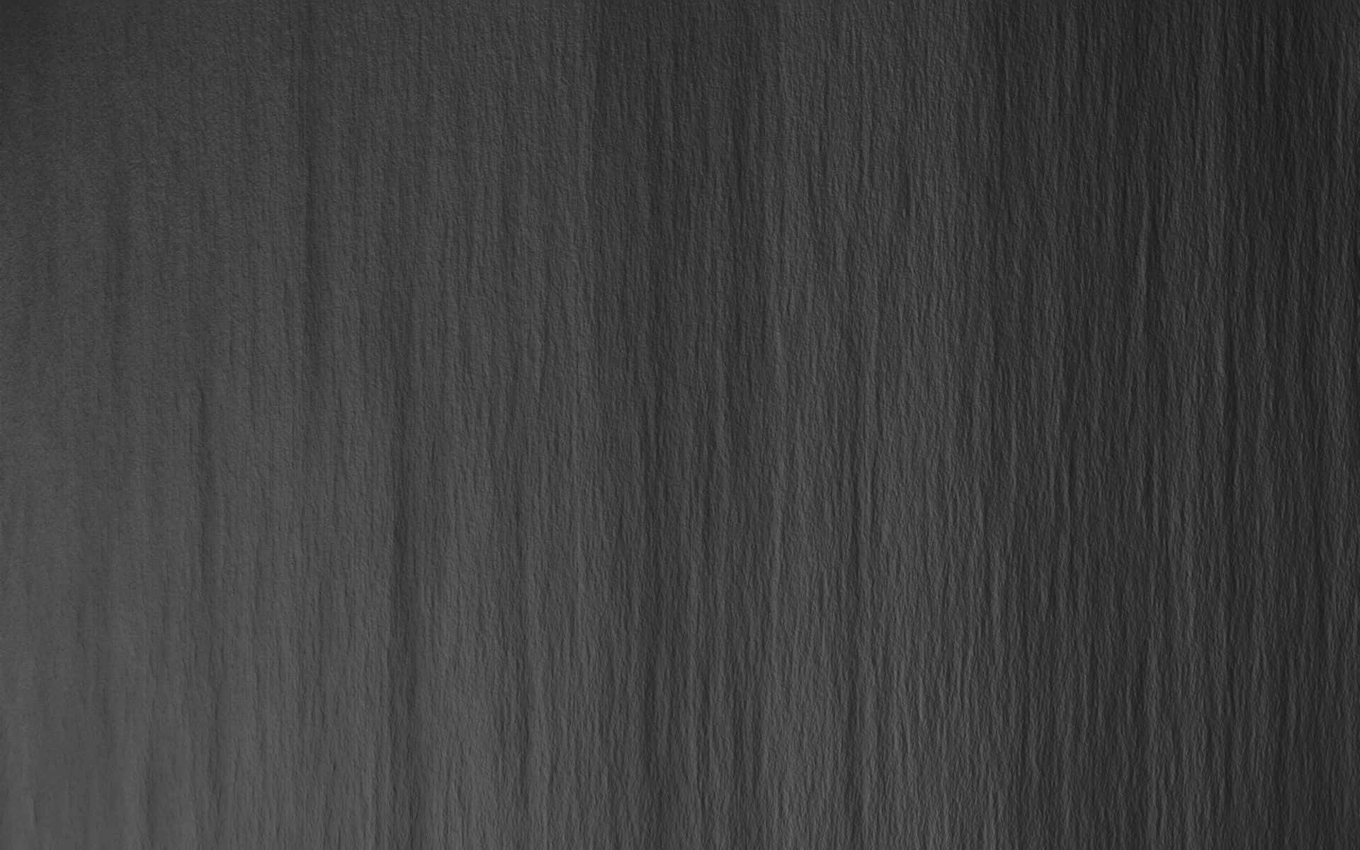 Grey Desktop 桌布 壁紙 — 深灰色紋理紙張的特寫，帶有微妙的垂直纖維和柔和陰影。