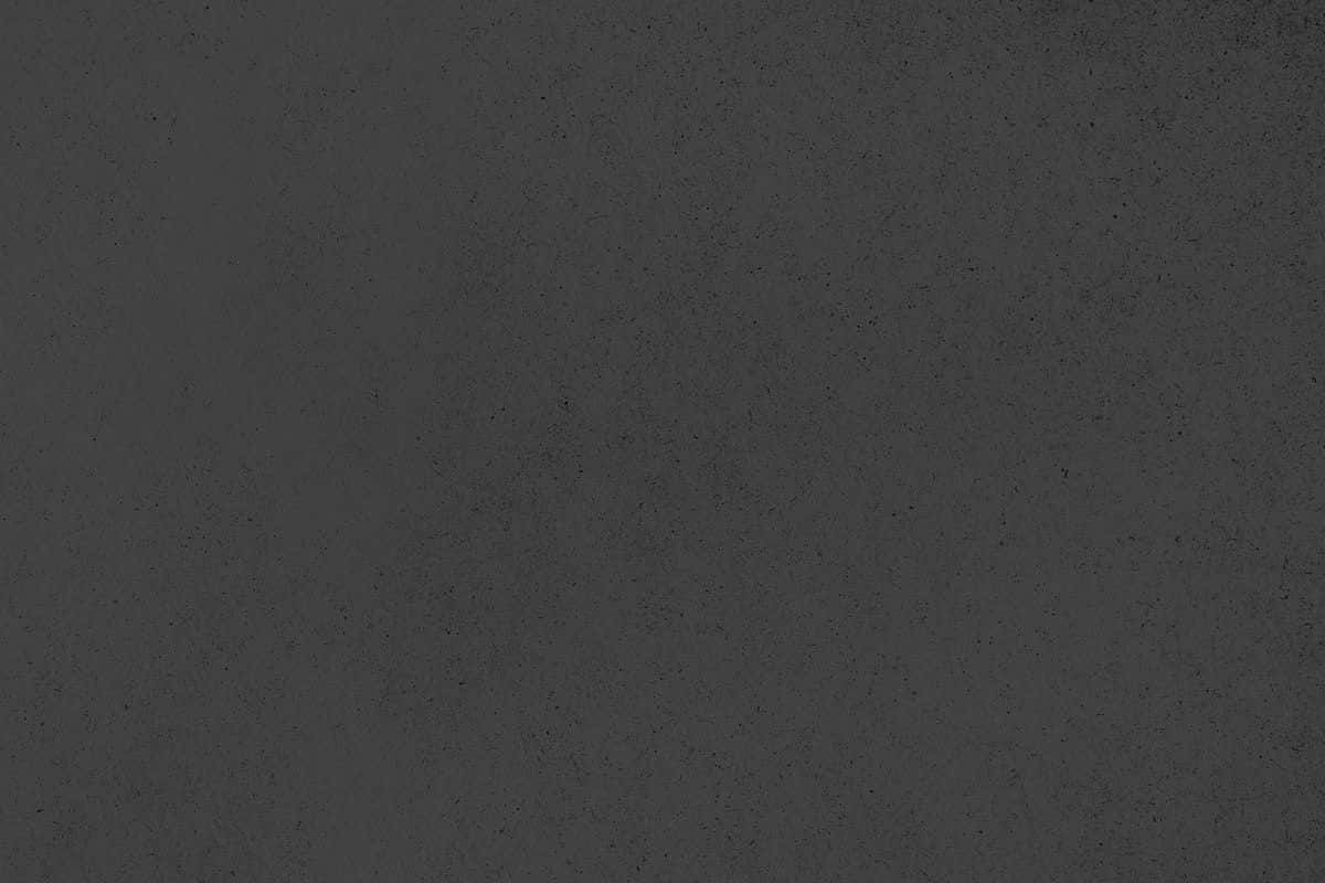 Black And Grey 桌布 壁紙 — 深灰色紋理紙張的特寫，帶有細微斑點和顆粒狀表面細節。
