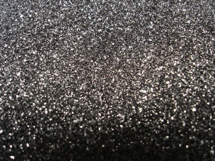 Black Ombre 桌布 壁紙 — 深灰色閃粉紋理的近距離特寫，帶有閃爍的銀色碎片捕捉光線。
