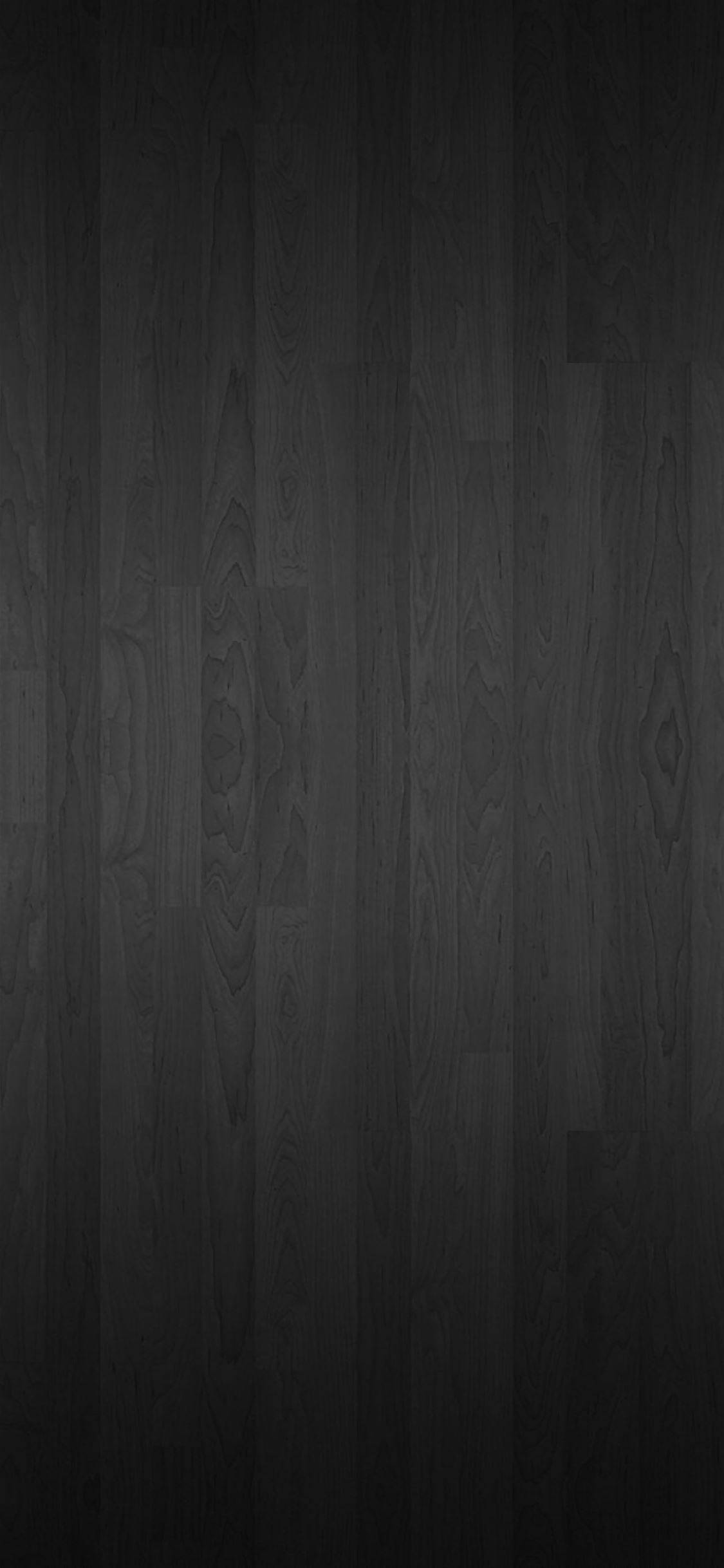 Wood Texture 桌布 壁紙 — 深炭色木地板，帶有細微木紋圖案和柔和垂直照明漸變。