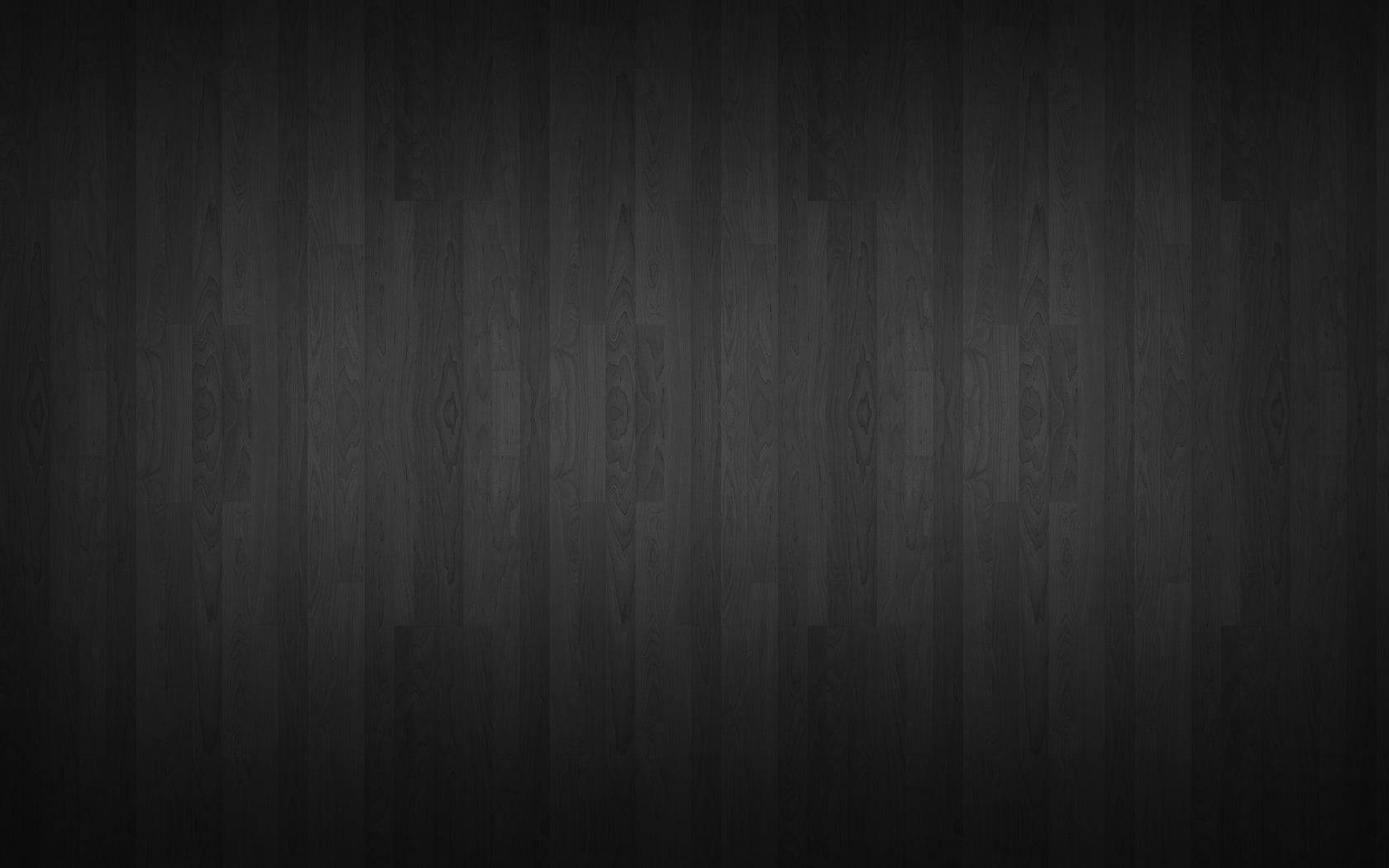 Dark Wall 桌布 壁紙 — 深炭色木地板，帶有細微木紋圖案和柔和漸變燈光。