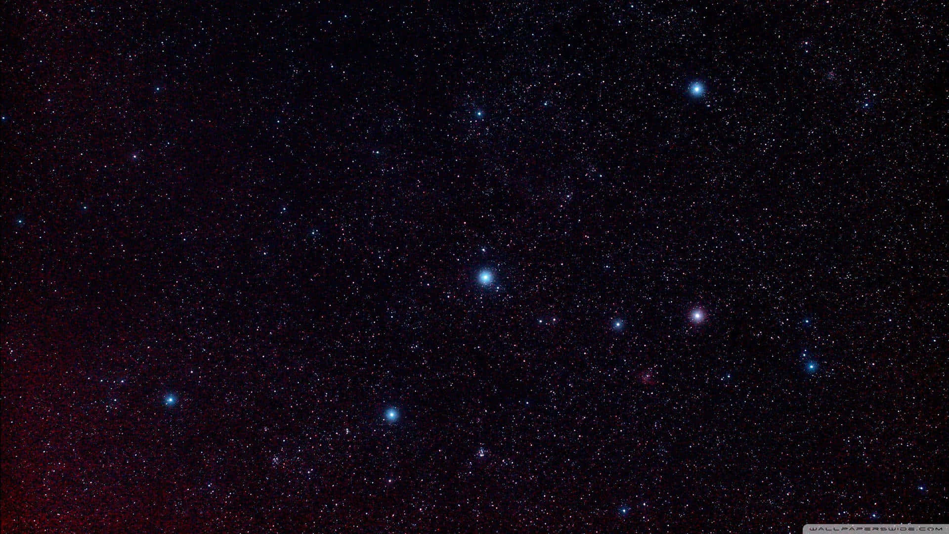 Stars Computer 桌布 壁紙 — 深空視野，充滿無數星星，左下角有微妙的紅色星雲光芒。