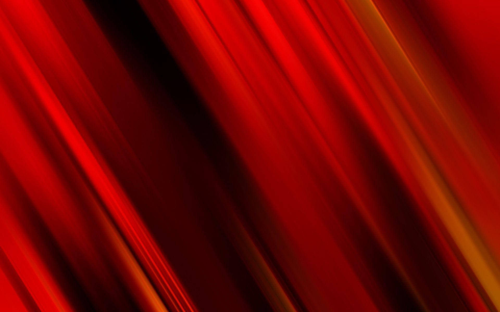 Red Color 桌布 壁紙 — 深紅色和橙色的鮮豔對角線條紋在深色背景上發光，營造出動態的抽象運動效果。