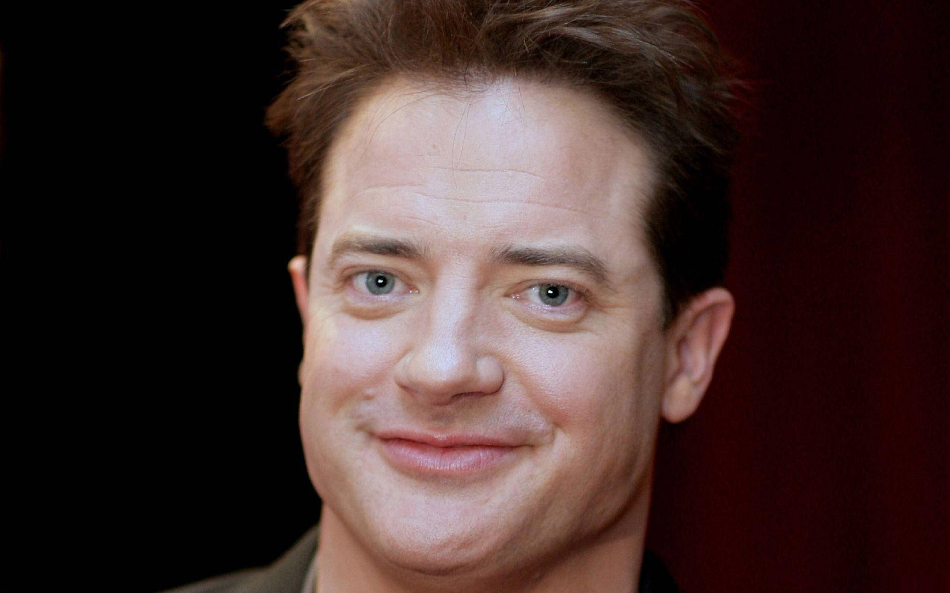 Celebrity 桌布 壁紙 — 深紅色背景前，一名棕色頭髮、藍色眼睛的男子微笑的特寫肖像。