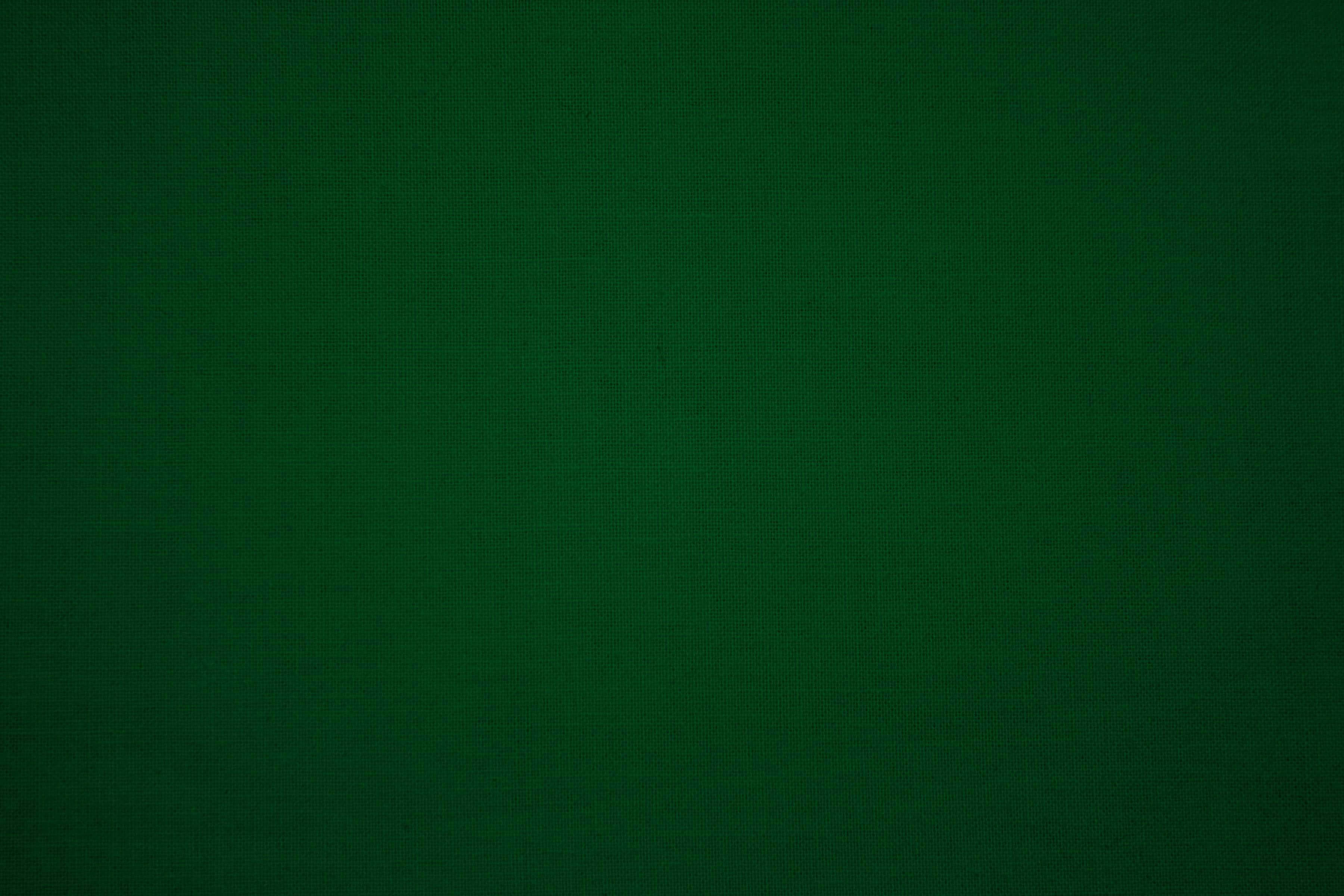 Forest Green 桌布 壁紙 — 深綠色豐富布料的特寫，帶有微妙的紋理編織圖案。