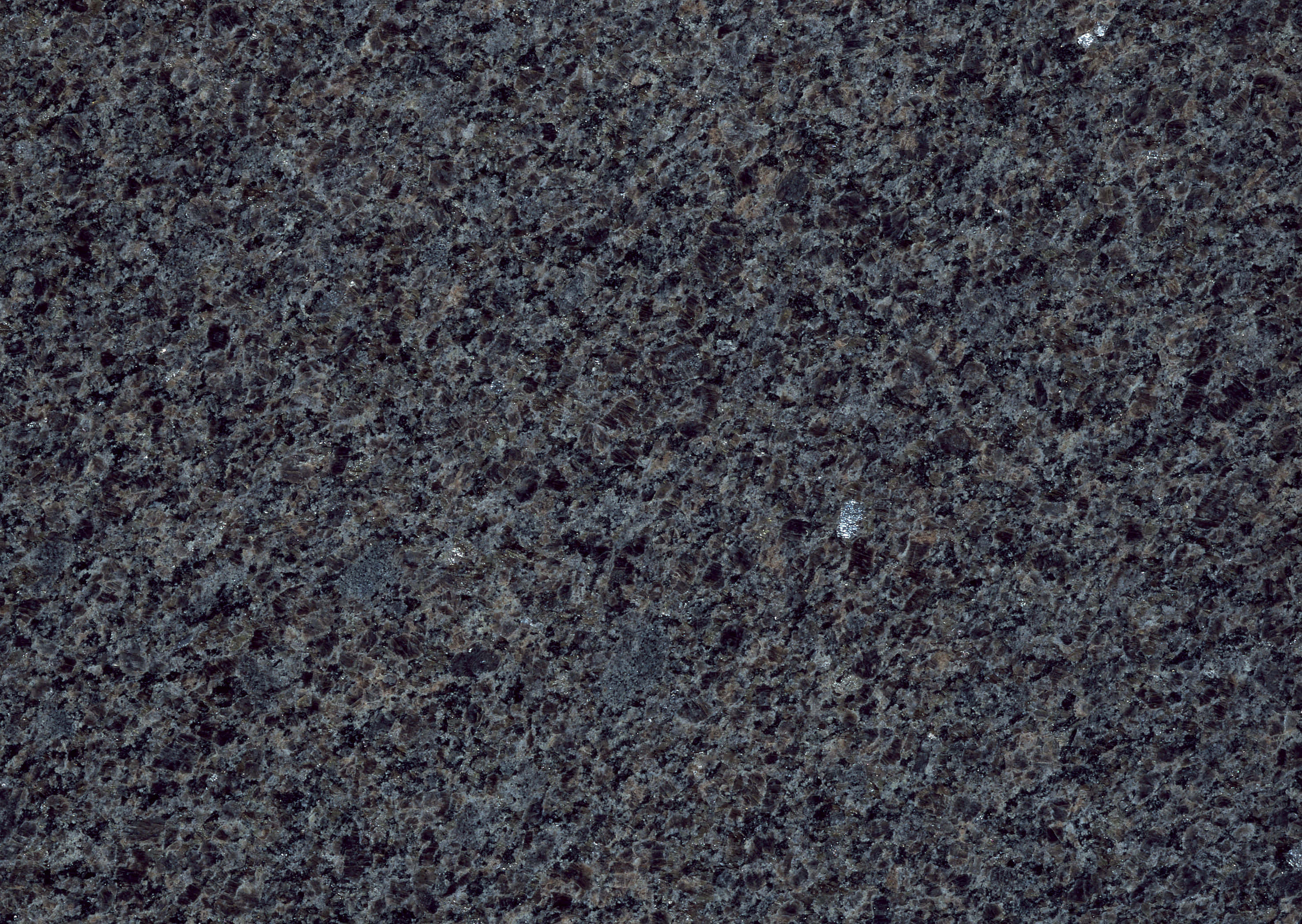 Granite 桌布 壁紙 — 深色斑點花崗岩表面的特寫，帶有灰色、白色和棕色的斑點，呈現天然石材紋理。