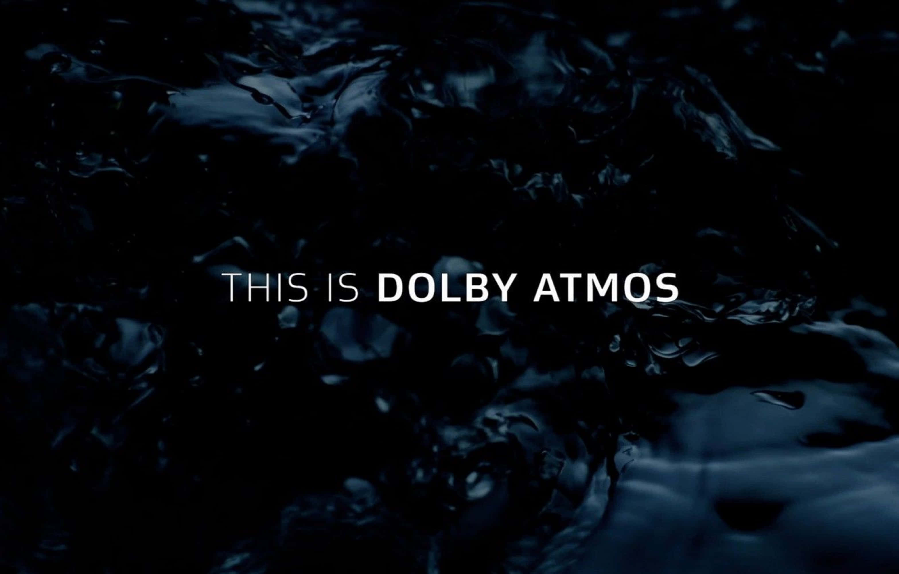 4K Dolby Vision 桌布 壁紙 — 深色漣漪水面上，螢幕中央有白色文字寫著「THIS IS DOLBY ATMOS」。