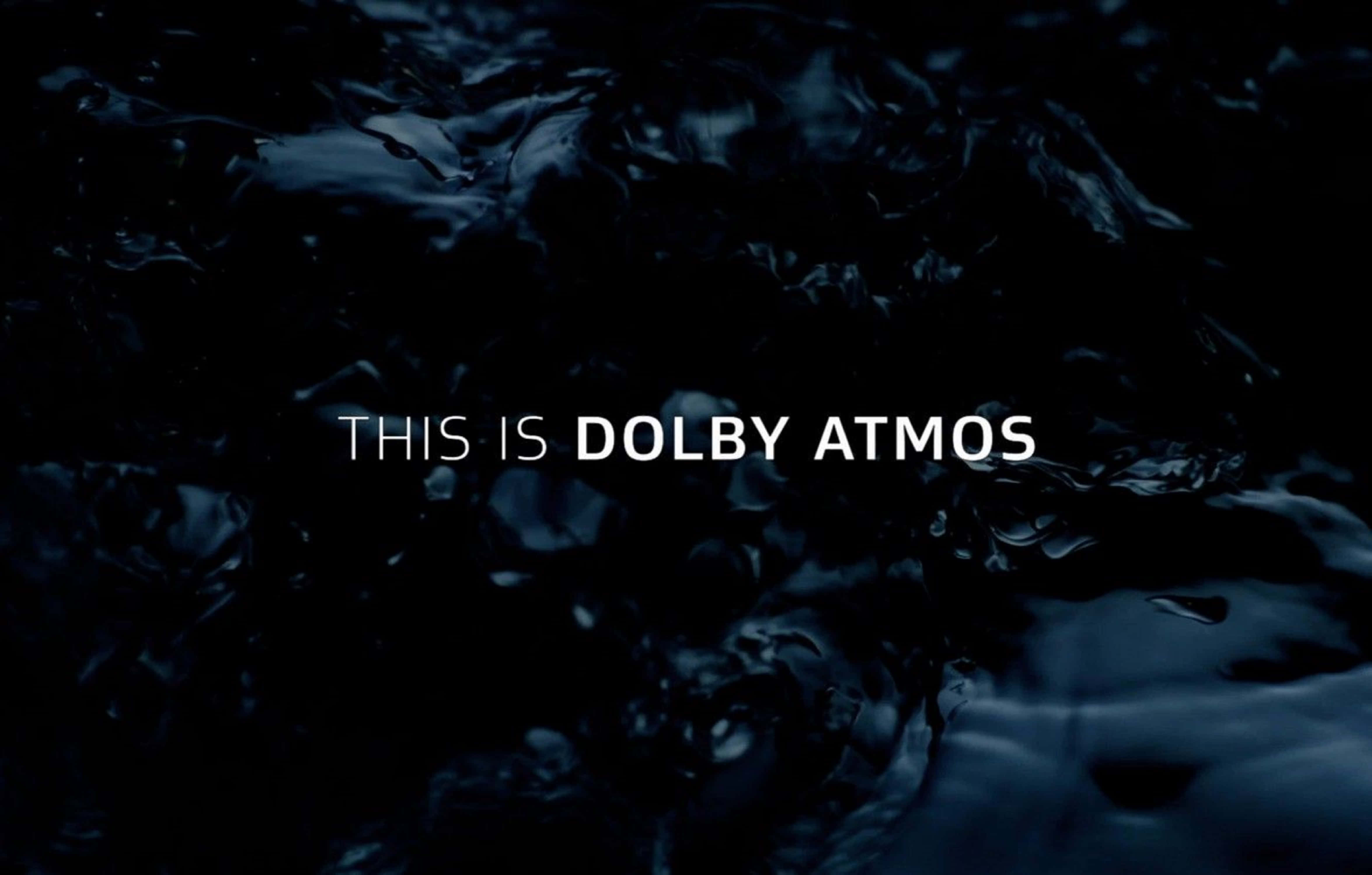 4K Dolby Vision 桌布 壁紙 — 深色漣漪水面上，螢幕中央顯示白色文字「THIS IS DOLBY ATMOS」。
