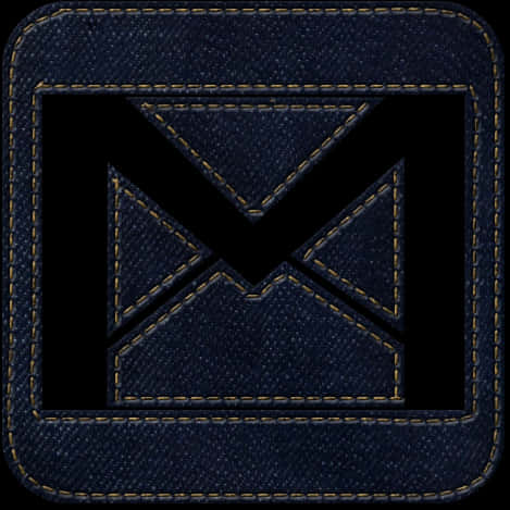 Gmail Logo 桌布 壁紙 — 深色牛仔布補丁，上面有縫製的黑色 'X' 標誌，以金色線條框住，背景為有紋理的布料。