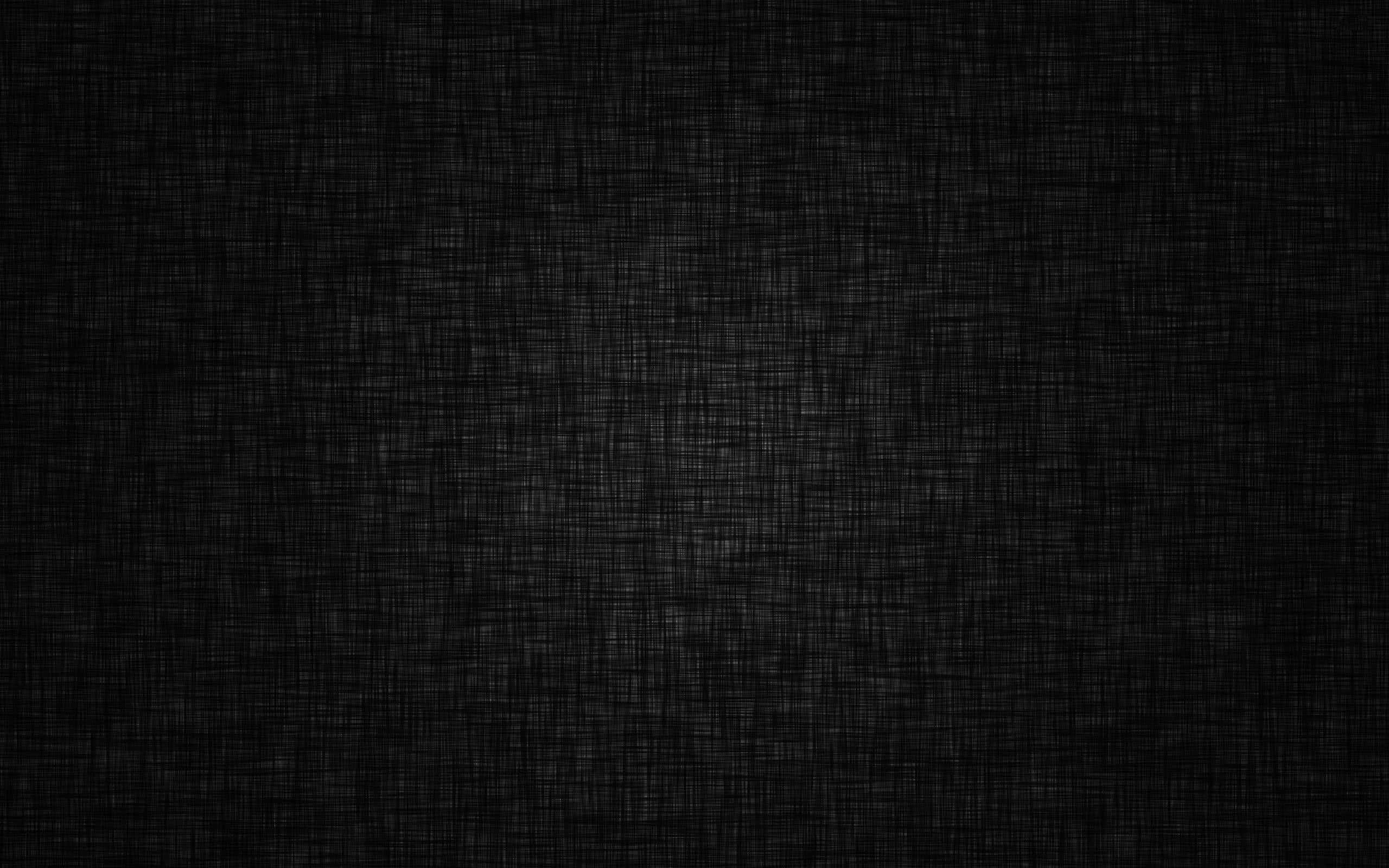 Dark Texture 桌布 壁紙 — 深色紋理布料的特寫，帶有微妙的編織圖案和微弱的光線變化。