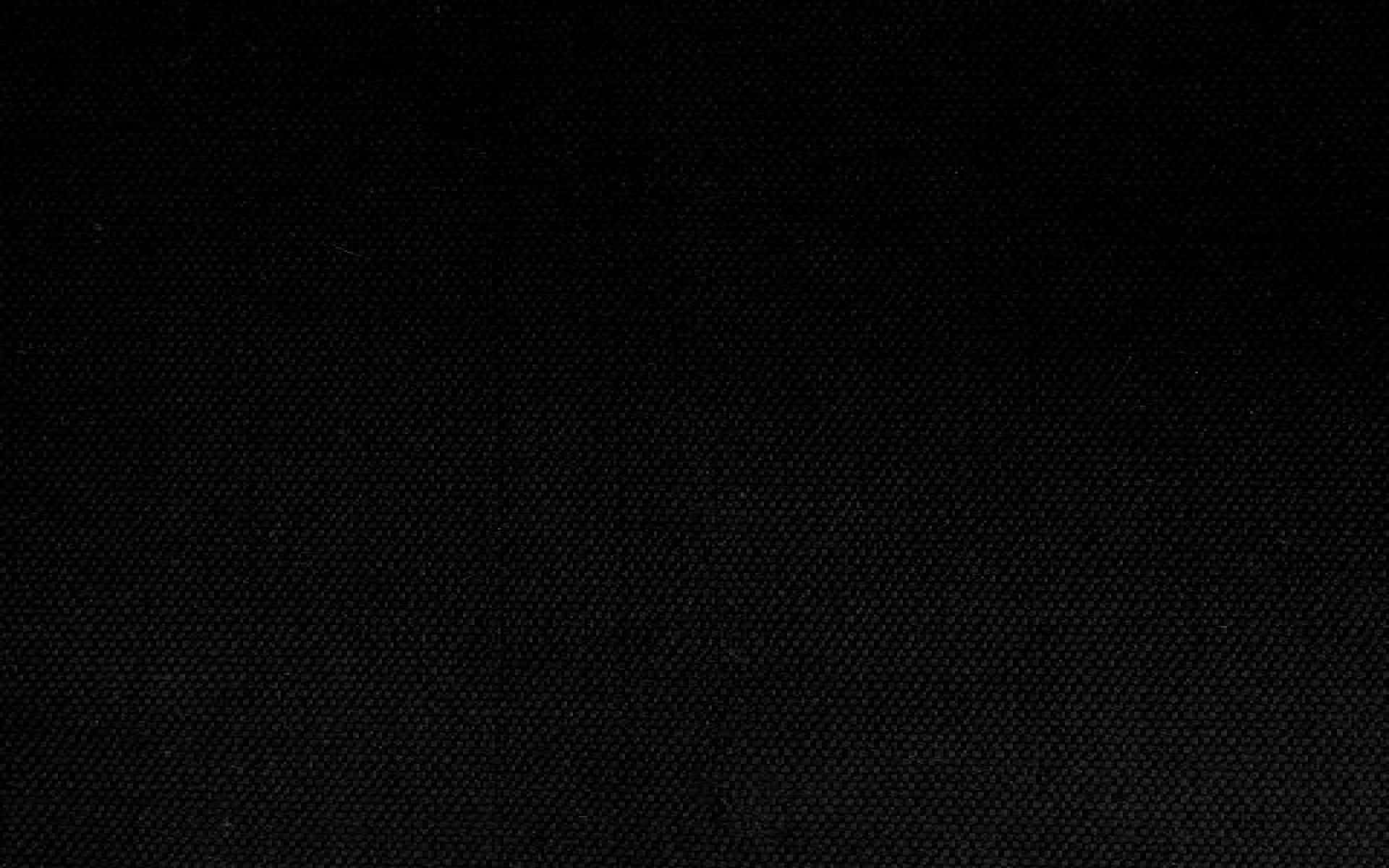 Pitch Black 桌布 壁紙 — 深色紋理布料表面的特寫，帶有微妙的編織圖案和微弱的光點。