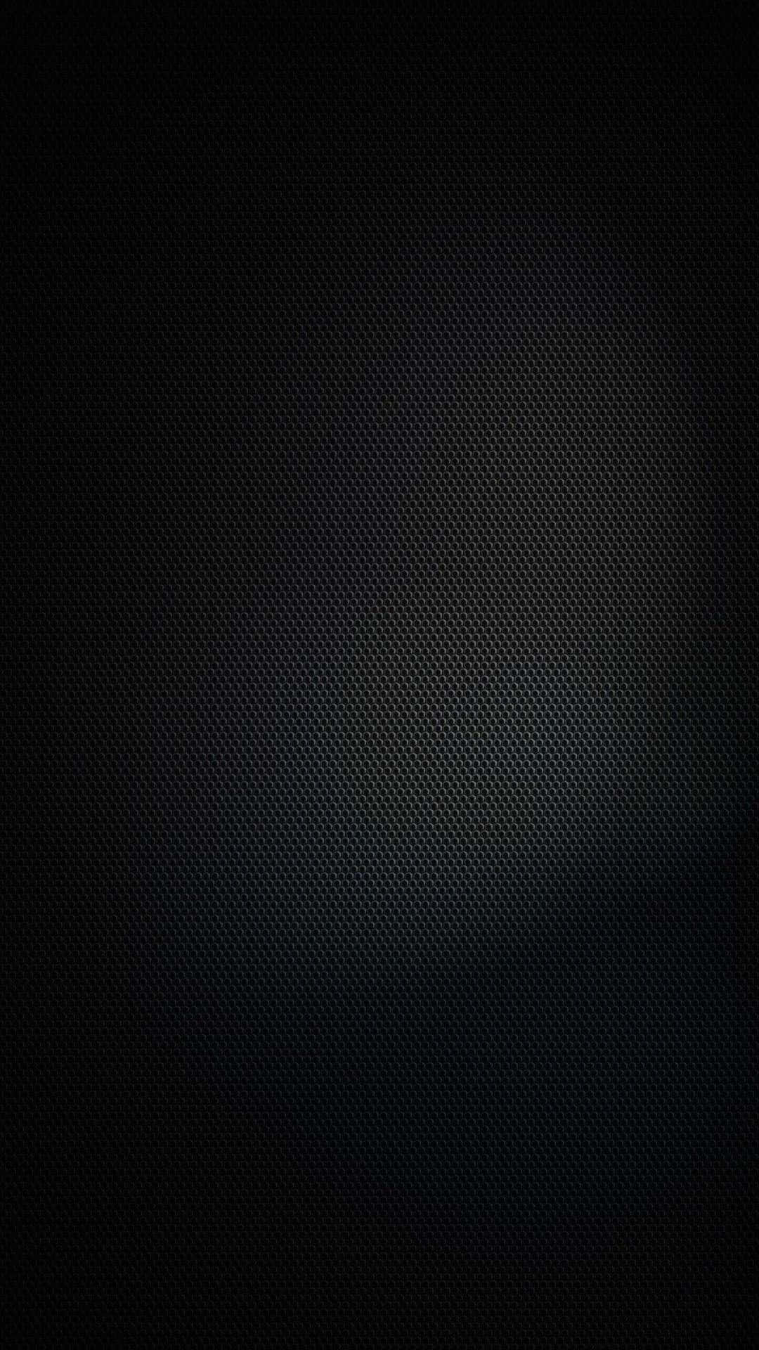 Vantablack 桌布 壁紙 — 深色紋理碳纖維表面，中央帶有微妙的漸變光暈。