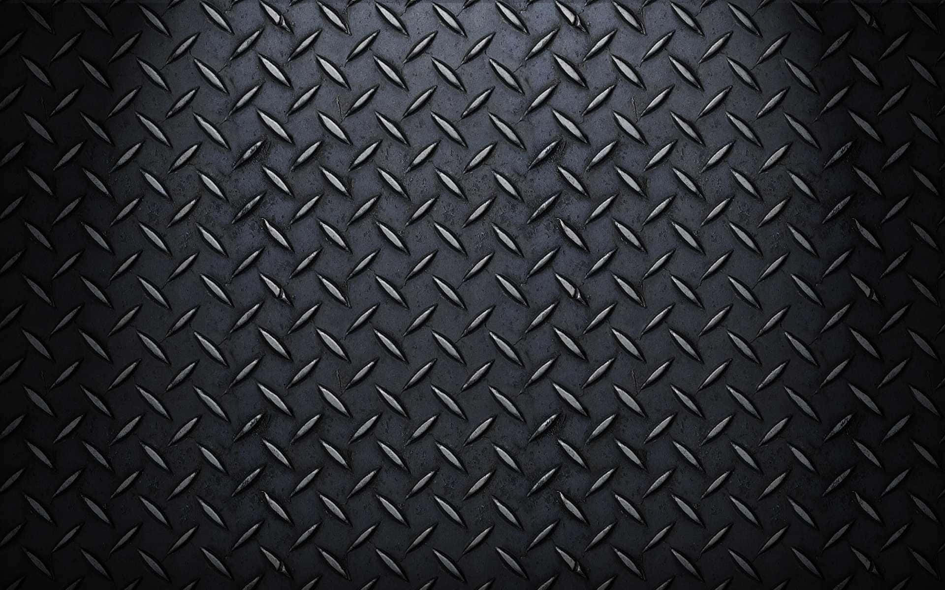 Diamond Plate 桌布 壁紙 — 深色紋理菱形板金屬的特寫，柔和光線突顯其工業脊線。