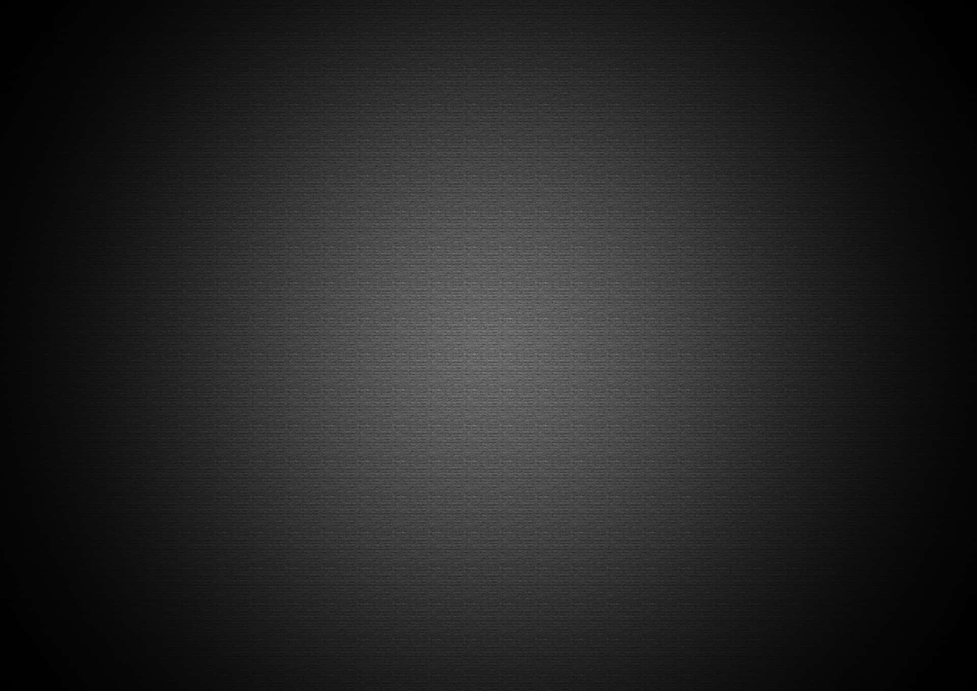 Gray Gradient 桌布 壁紙 — 深色紋理表面，帶有從中心向外漸變的柔和漸變燈光。