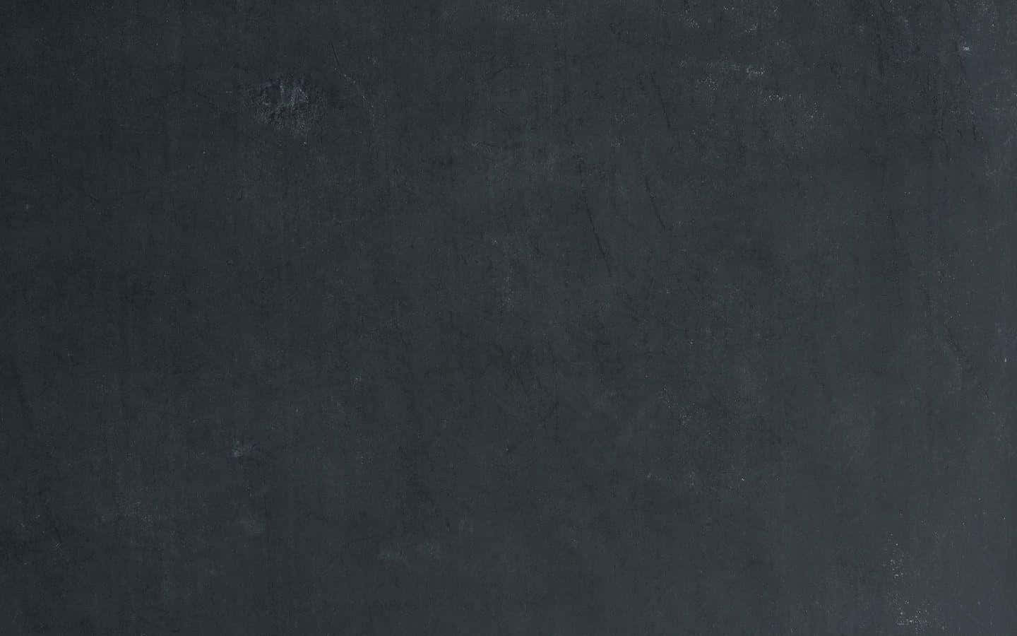 Faded 桌布 壁紙 — 深色紋理表面的特寫，帶有微妙的灰色變化和輕微的刮痕。
