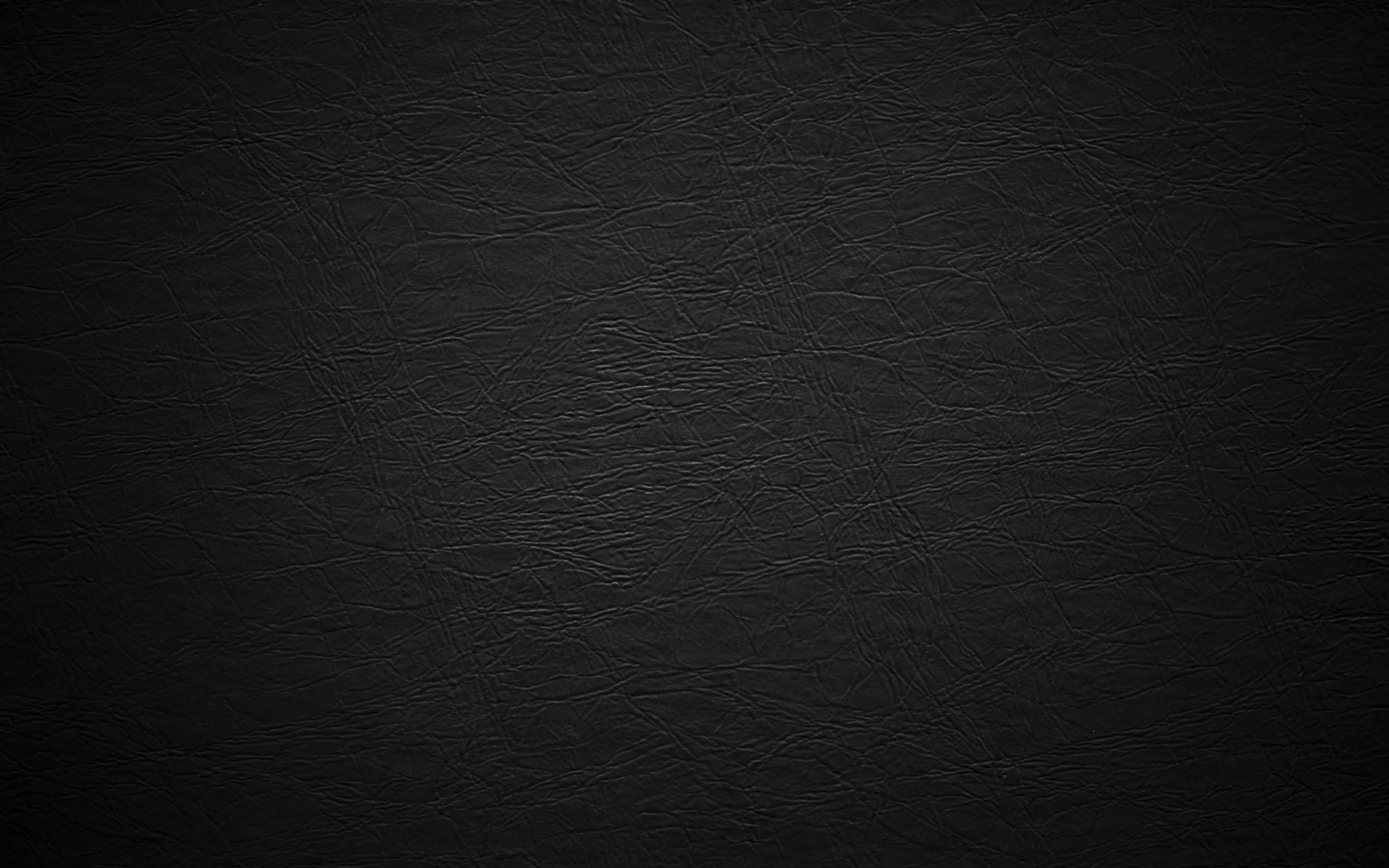 texture 桌布 壁紙 — 深色紋理黑色皮革表面的特寫，帶有細微皺紋和天然粒面圖案。