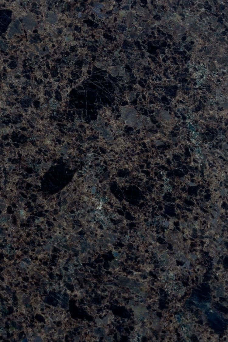 Granite 桌布 壁紙 — 深色花崗岩的近距離特寫，帶有複雜的金色和灰色礦物脈絡，營造出奢華的天然石材紋理。