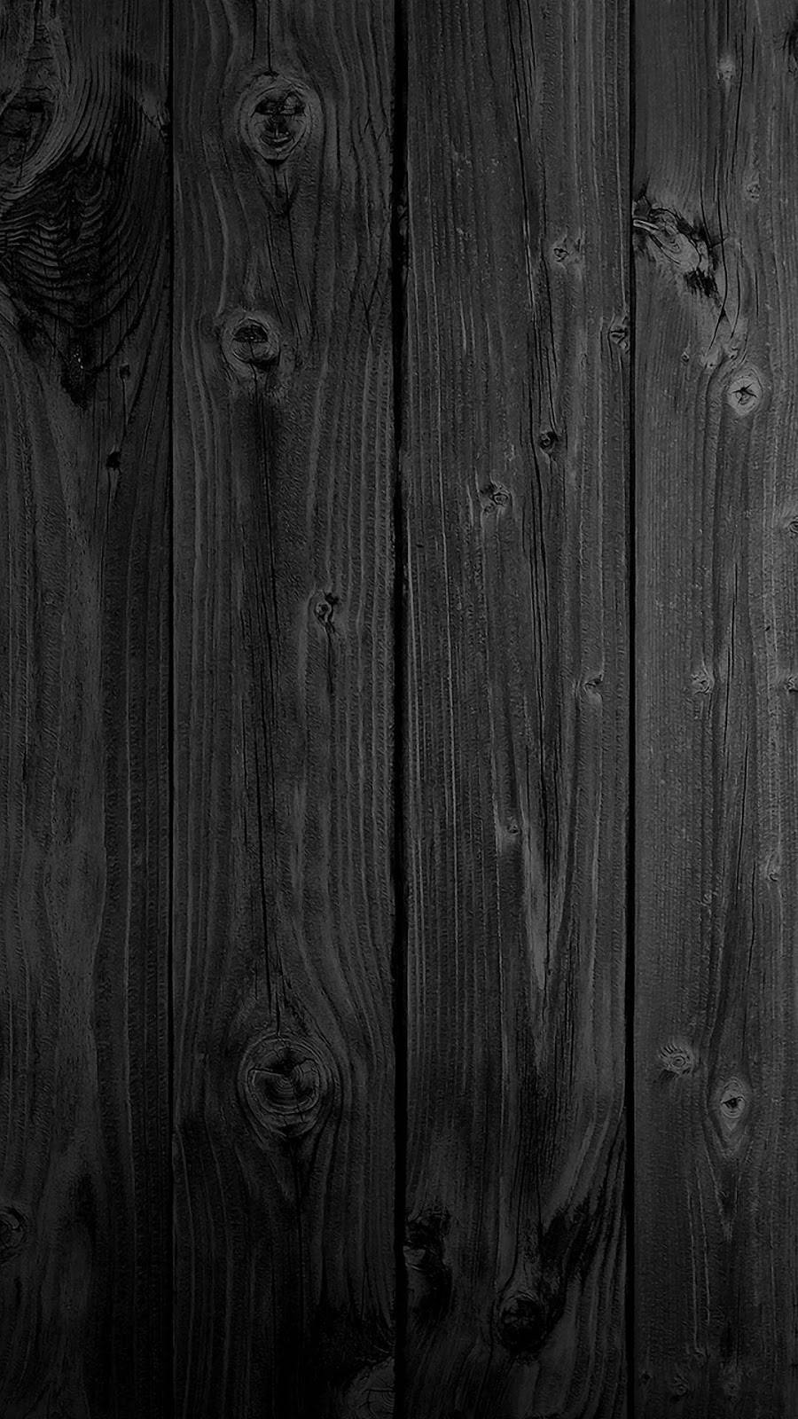 minimal dark iPhone 桌布 壁紙 — 深色風化木板，帶有深紋理和節疤，營造出陰鬱的鄉村質感。