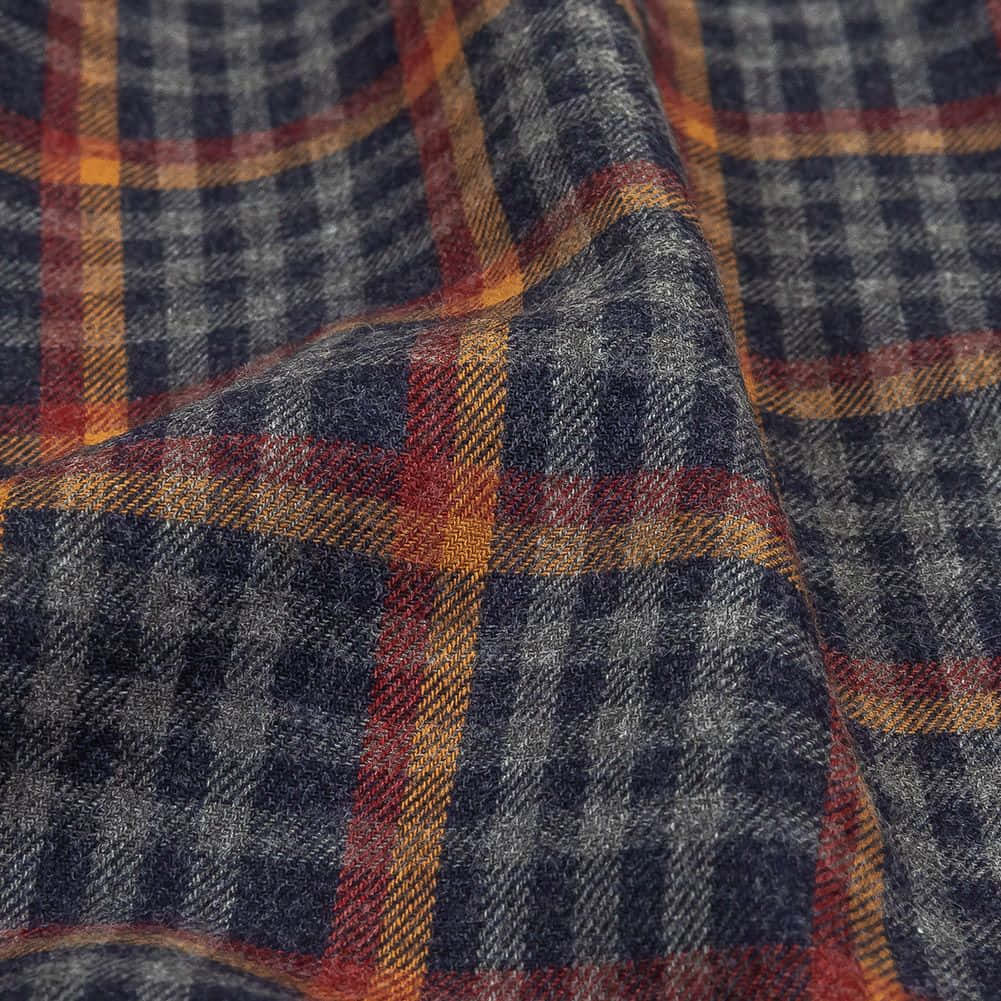 Fabric 桌布 壁紙 — 深藍灰色與溫暖橙紅色條紋柔軟折疊的紋理格子布料的特寫。