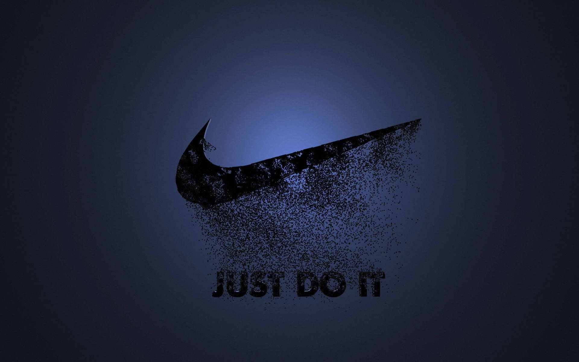 酷炫耐吉 桌布 壁紙 — 深藍色Nike勾勾標誌分解成粒子，下方有「JUST DO IT」文字，背景為漸層色。