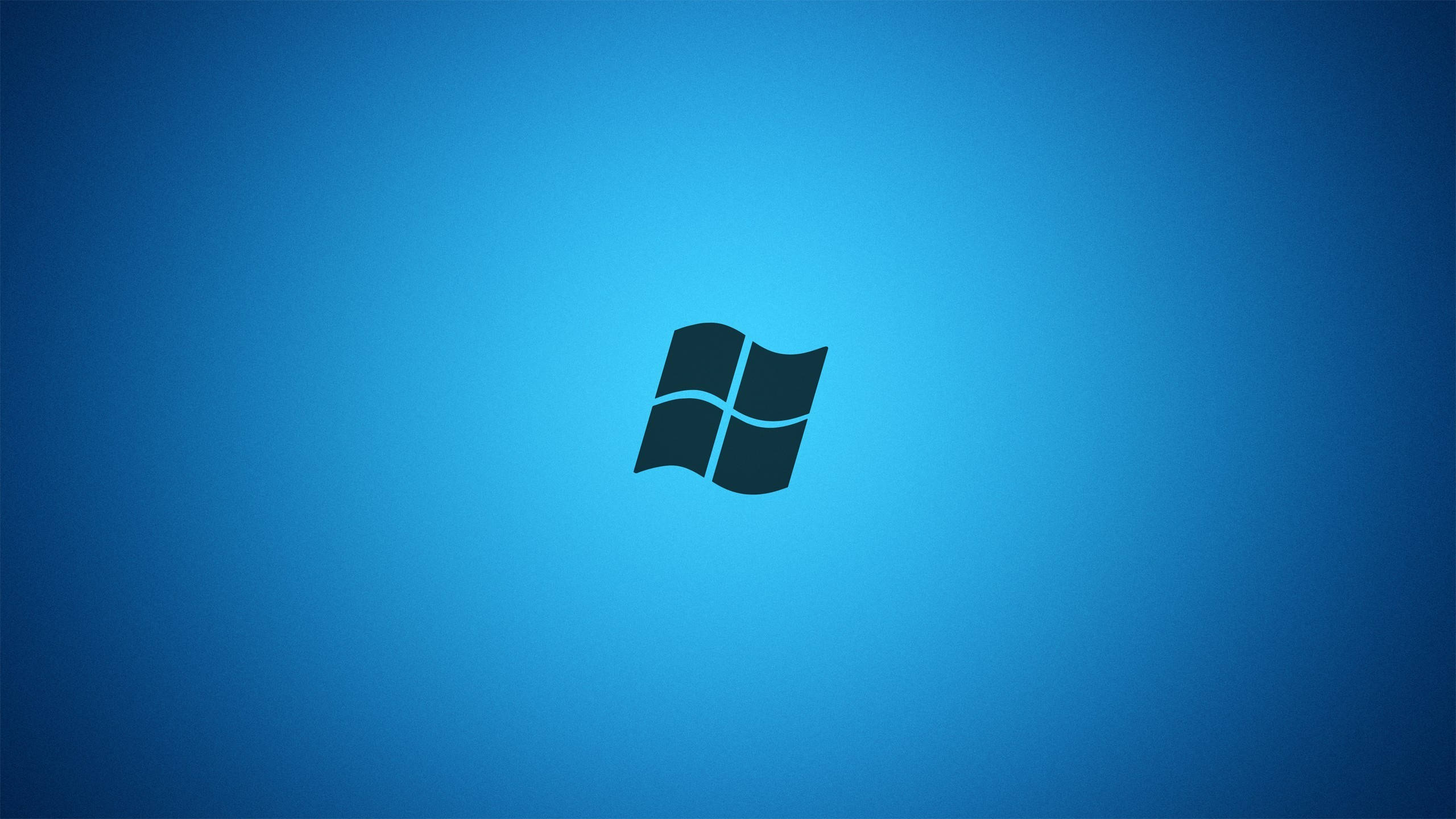 Windows 7 桌布 壁紙 — 深藍色Windows標誌居中於漸變藍色背景上，帶柔和燈光。