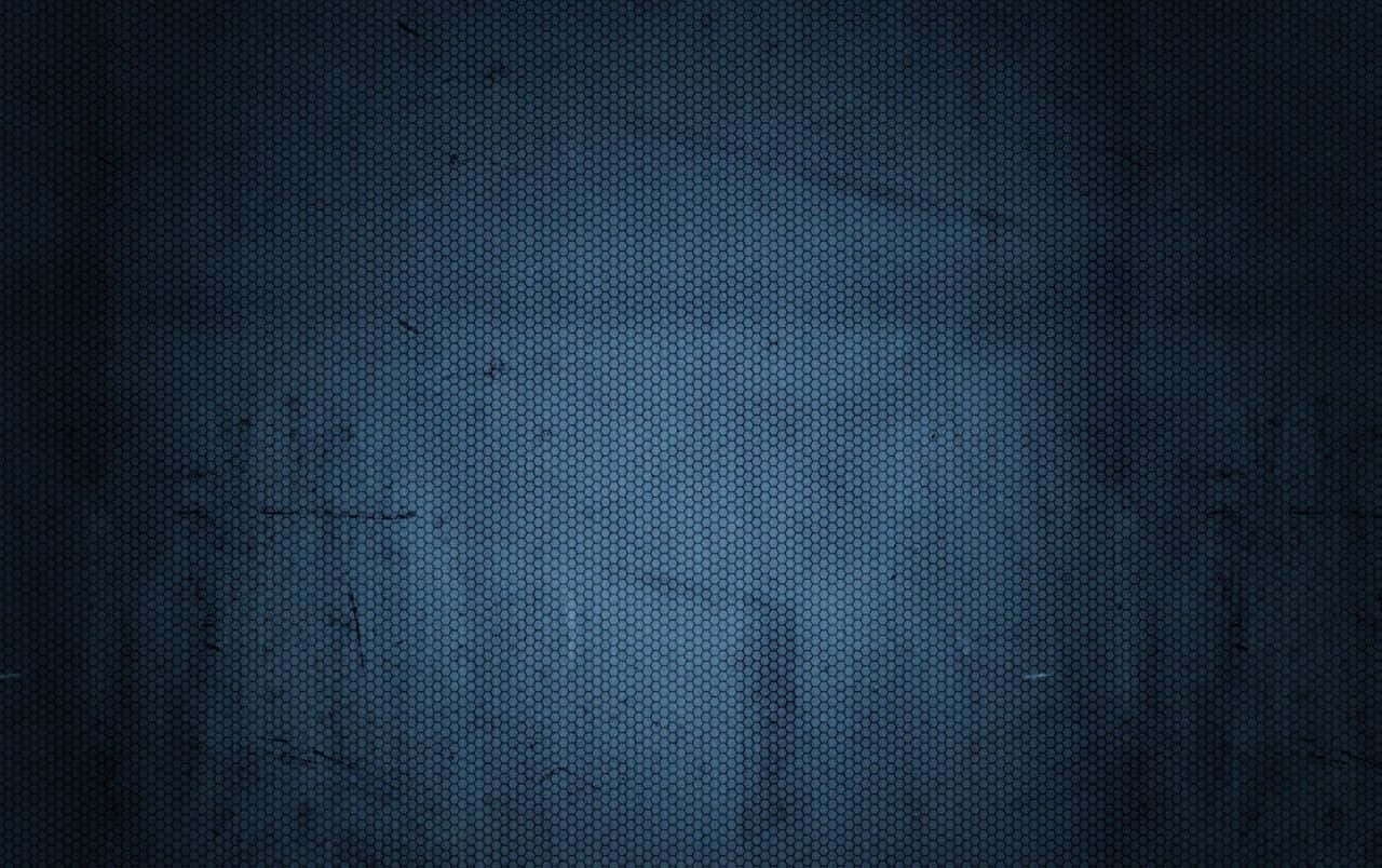 Dark Textured 桌布 壁紙 — 深藍色六角形網格紋理，帶有微妙的漸變和粗糙表面上的輕微刮痕。