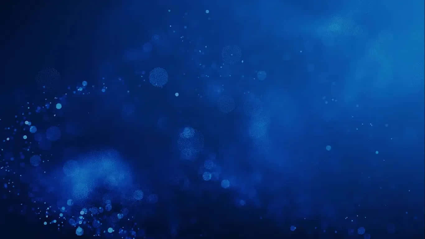 Blue Zoom 桌布 壁紙 — 深藍色抽象背景，帶有如宇宙塵埃般飄動的發光散景粒子。
