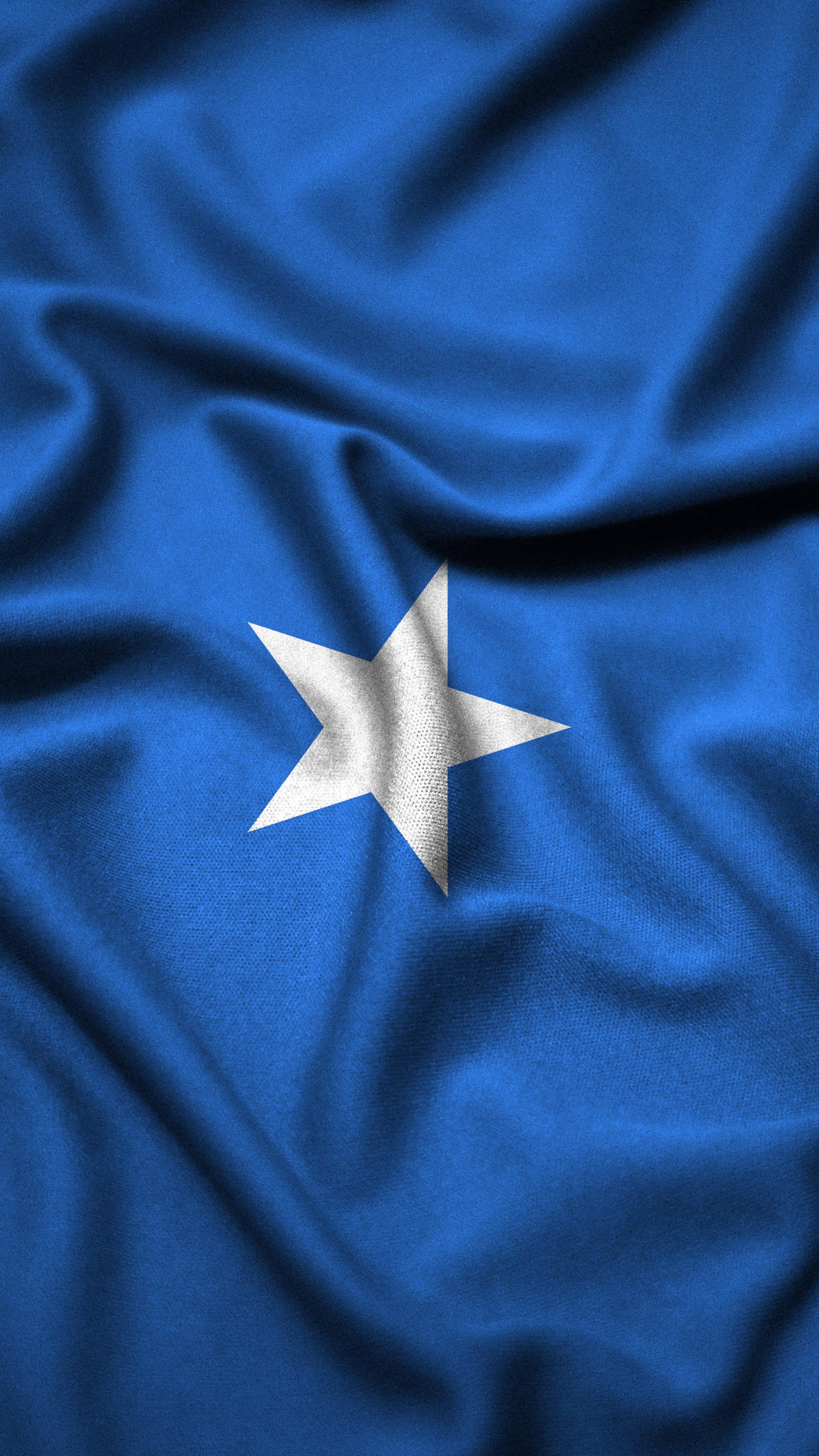 Somalia 桌布 壁紙 — 深藍色旗幟的特寫，白色五角星居中，布料質感褶皺。