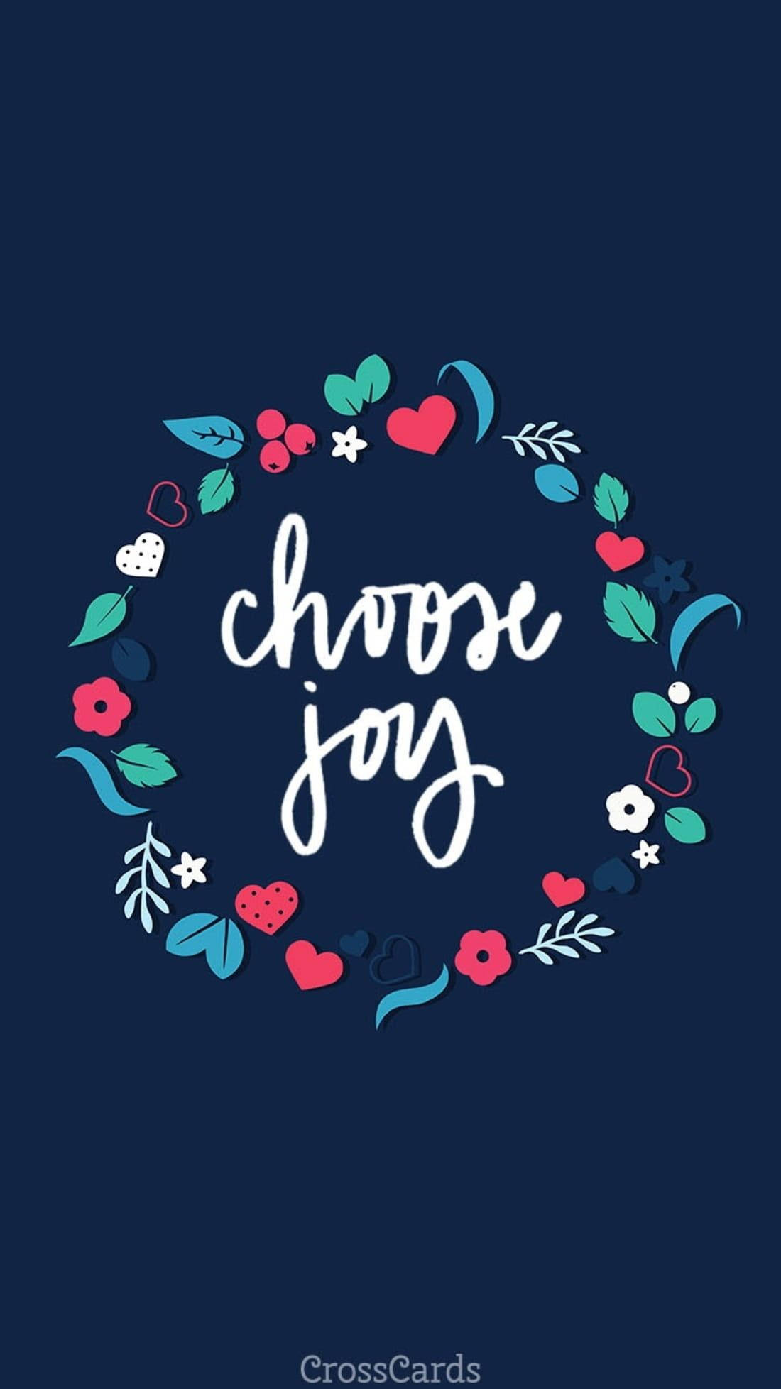 喜悅 桌布 壁紙 — 深藍色桌布上，白色草書字體寫著「choose joy」，周圍環繞著色彩繽紛的心形、花朵和葉子花環。