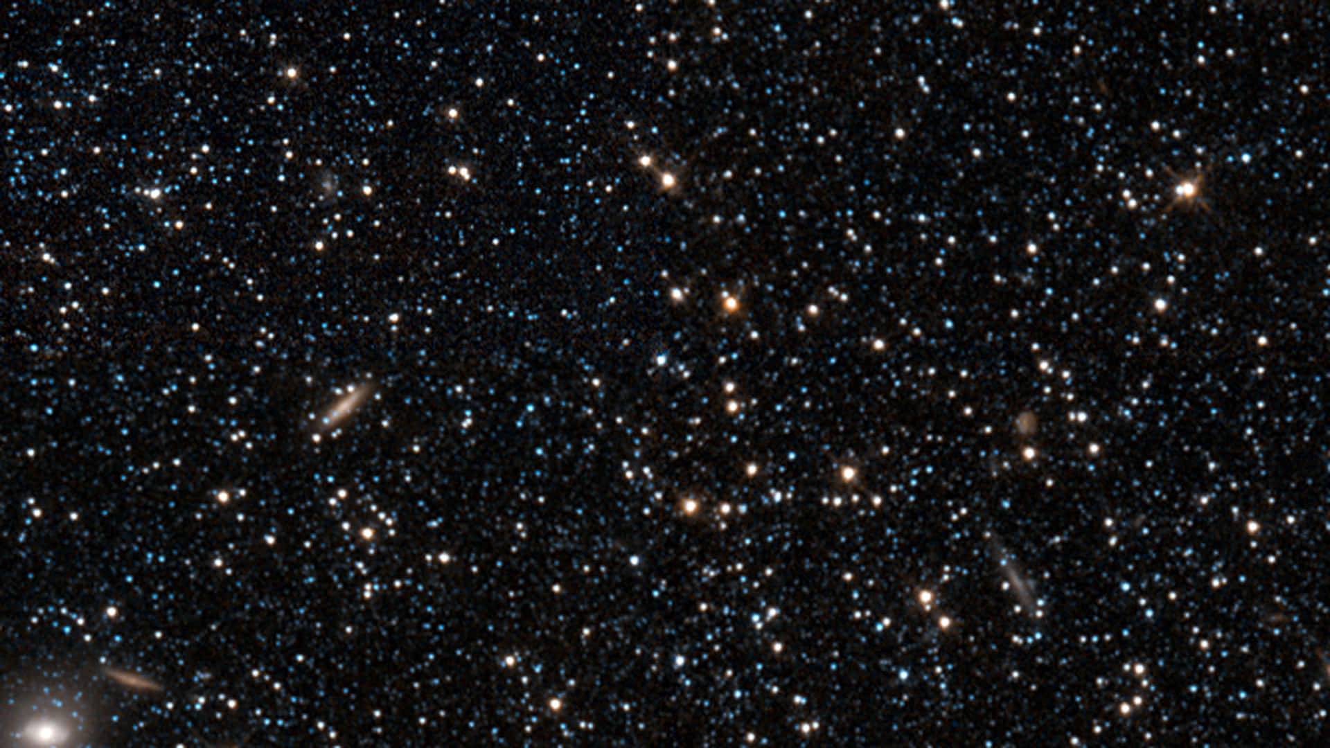 桌布 壁紙 — 深邃太空景觀，充滿無數恆星和暗淡螺旋星系，背景是黑色虛空。