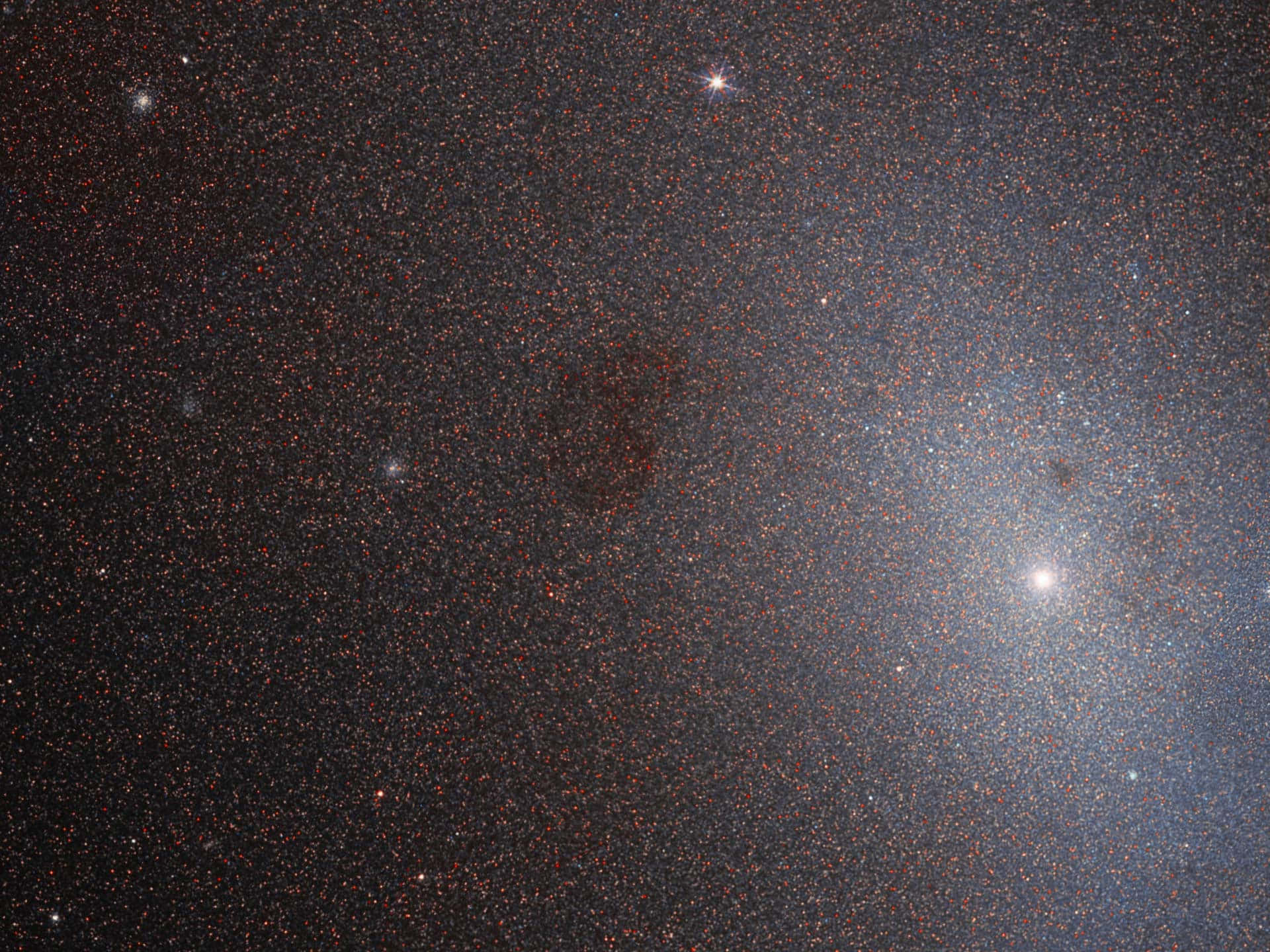 Elliptical Galaxy 桌布 壁紙 — 深邃太空景觀，充滿無數恆星和發光星雲，映襯著黑暗的宇宙背景。
