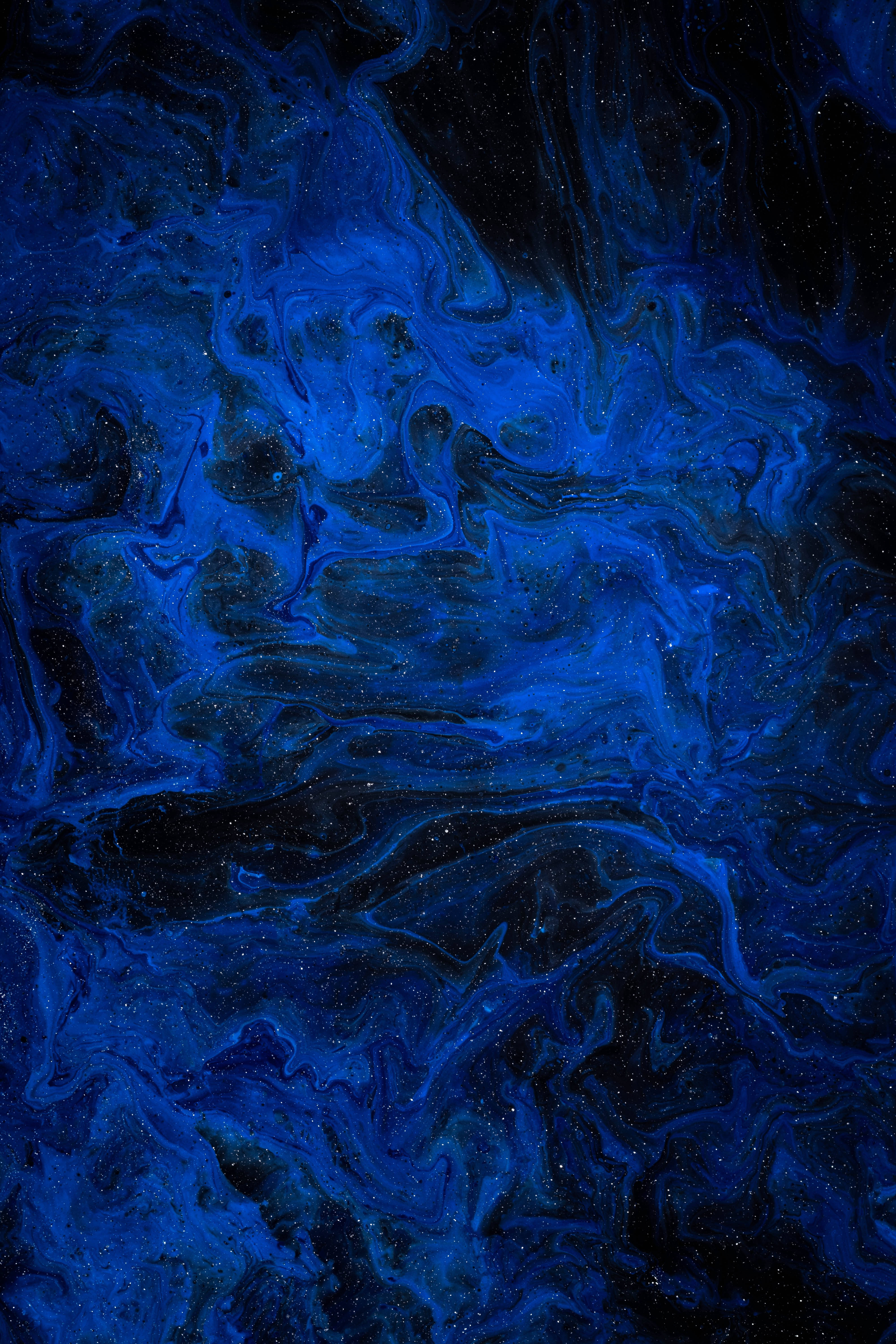 深藍色 桌布 壁紙 — 深邃的宇宙藍色漩渦帶著閃爍的斑點，像星雲一樣在黑暗虛空中飄移。