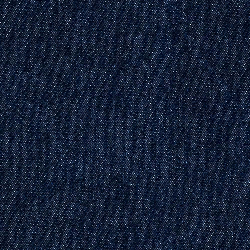 Denim Blue 桌布 壁紙 — 深靛藍色牛仔布料的特寫，顯示出有紋理的編織和微妙的褪色圖案。