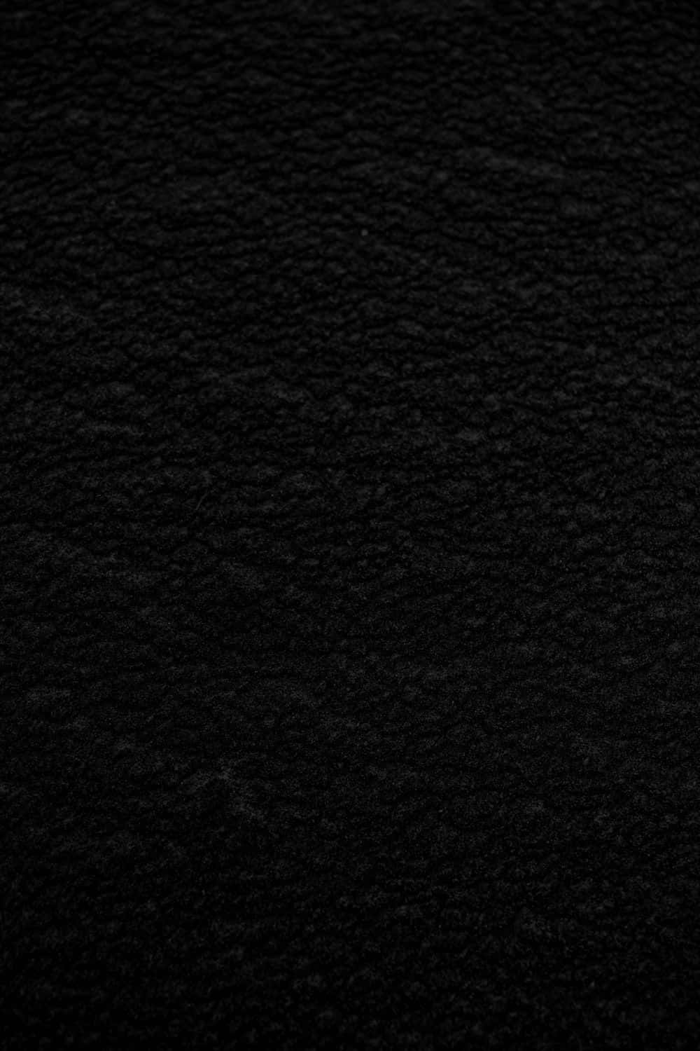 Dark Grey 桌布 壁紙 — 深黑色紋理布料的特寫，帶有細膩的編織圖案和柔軟纖維。