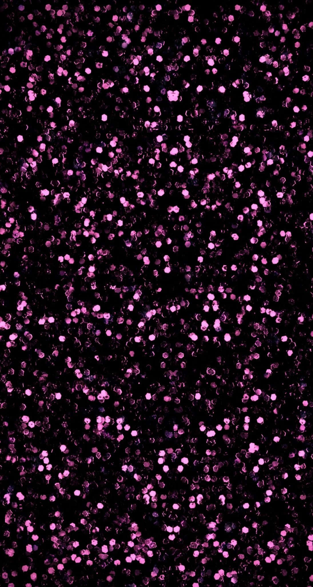Sparkle 桌布 壁紙 — 深黑色背景上散佈著密集的閃爍粉紅亮粉粒子。