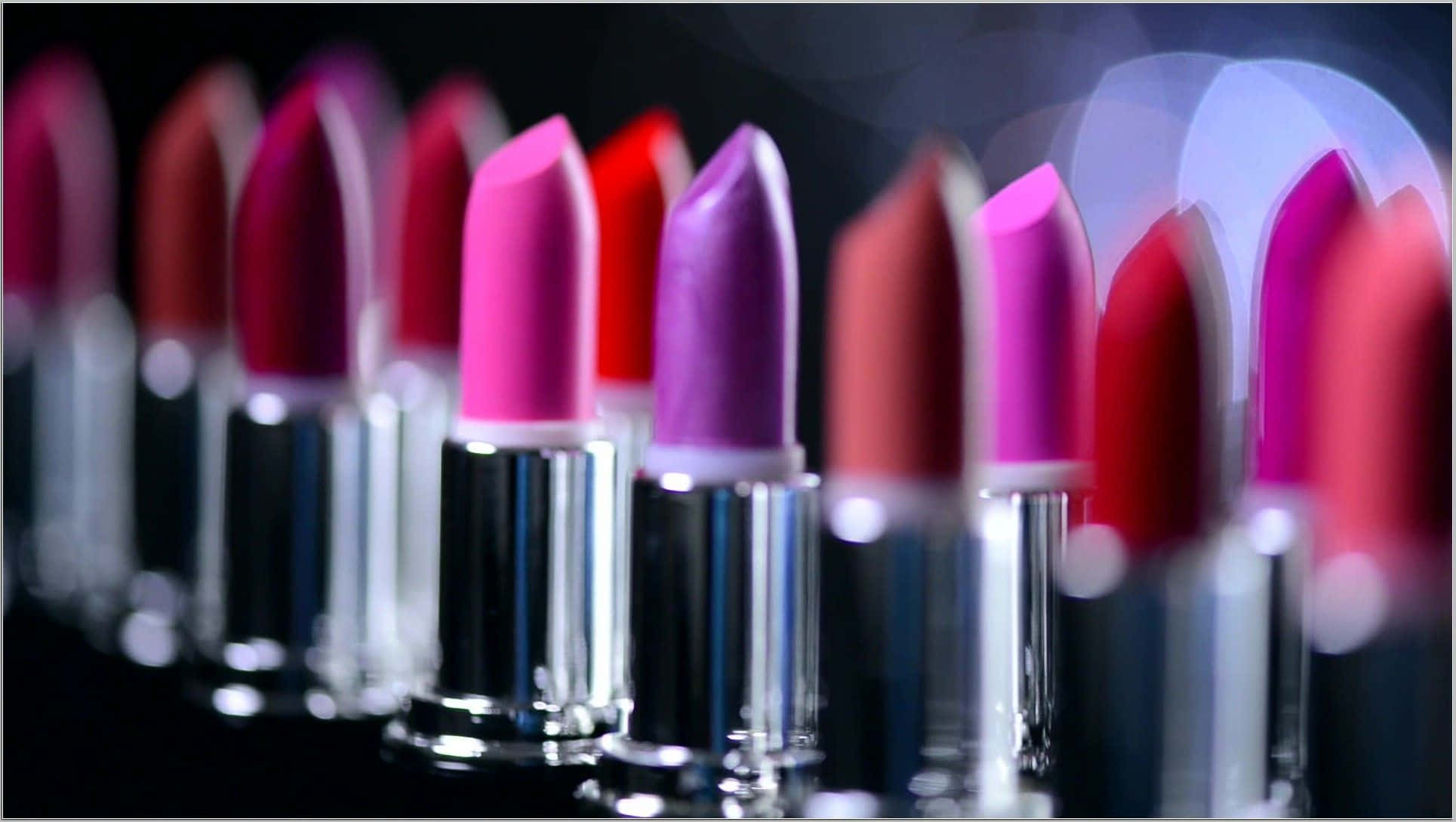 Cosmetics 桌布 壁紙 — 淺景深突出深色背景上帶有散景燈光的鮮豔粉紅色和紫色唇膏。