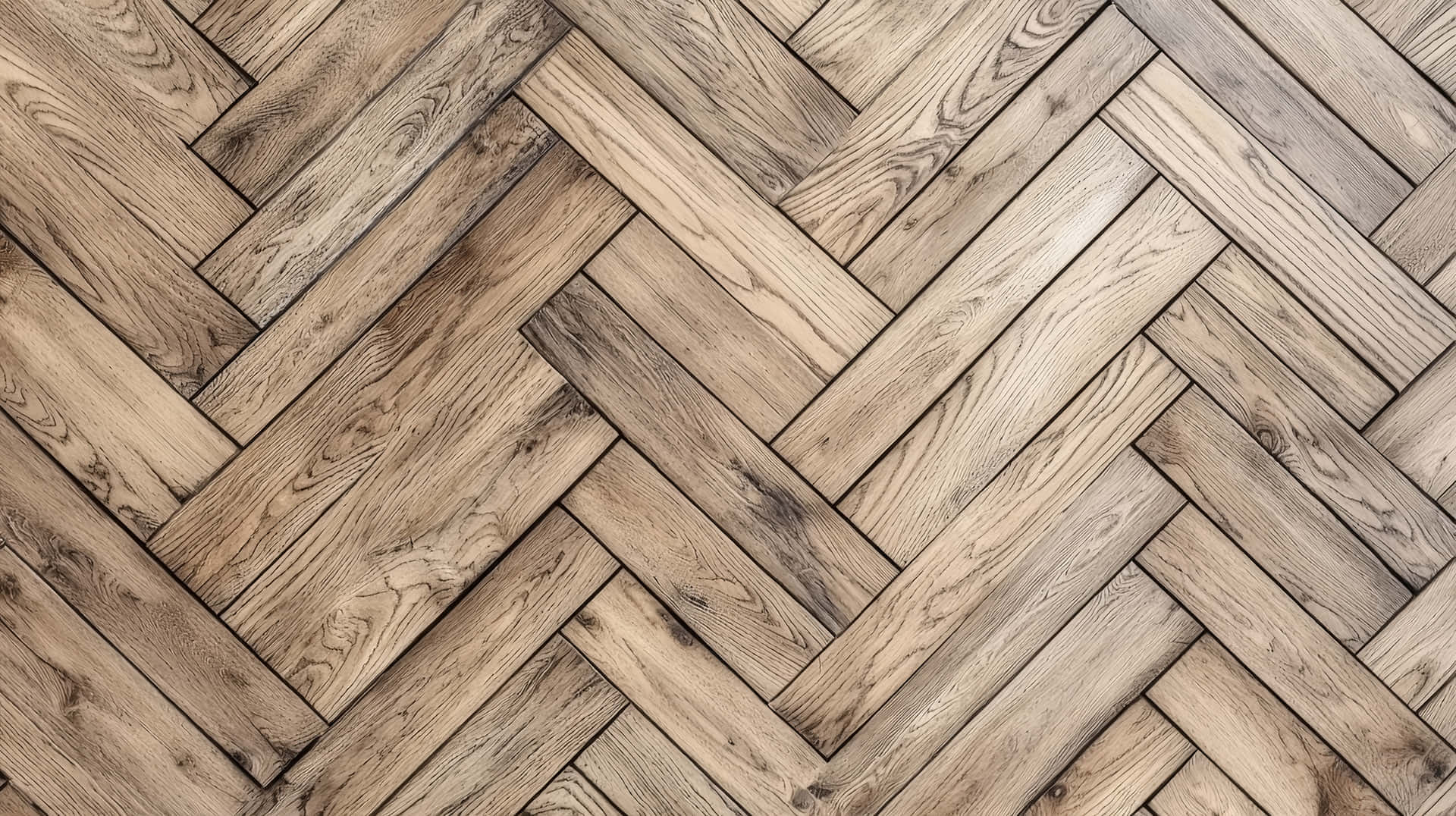 Herringbone pattern wooden floor with natural wood texture 壁紙 — 淺棕色木板以經典人字形圖案排列的特寫，展現天然木紋和質感。