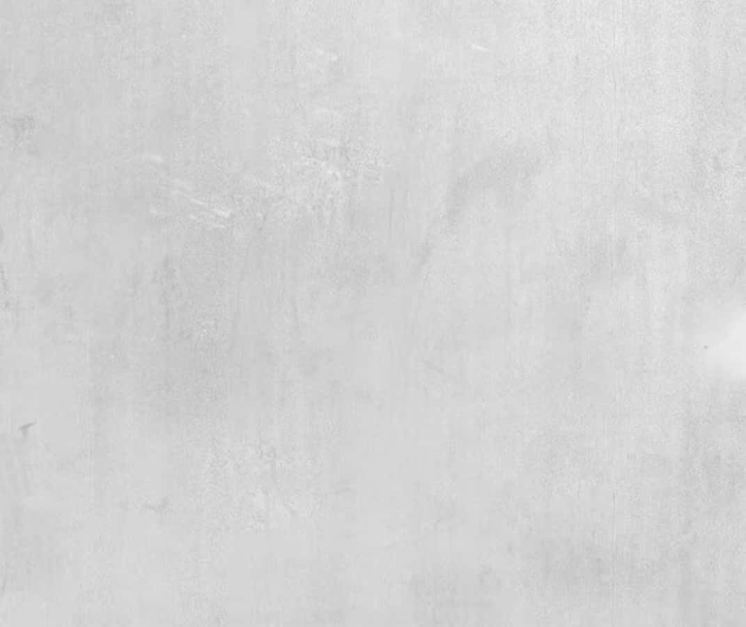 White Wall 桌布 壁紙 — 淺灰色光滑混凝土牆的近距離特寫，帶有細微紋理和淡淡污漬。