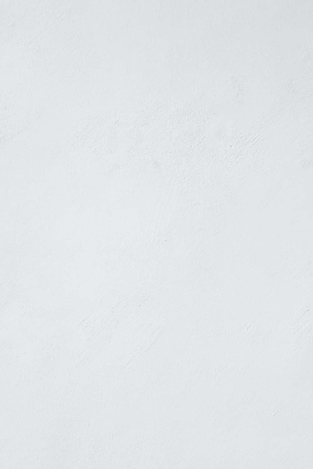 White Wall 桌布 壁紙 — 淺灰色光滑牆壁的特寫，帶有細微紋理和柔和均勻的光線。