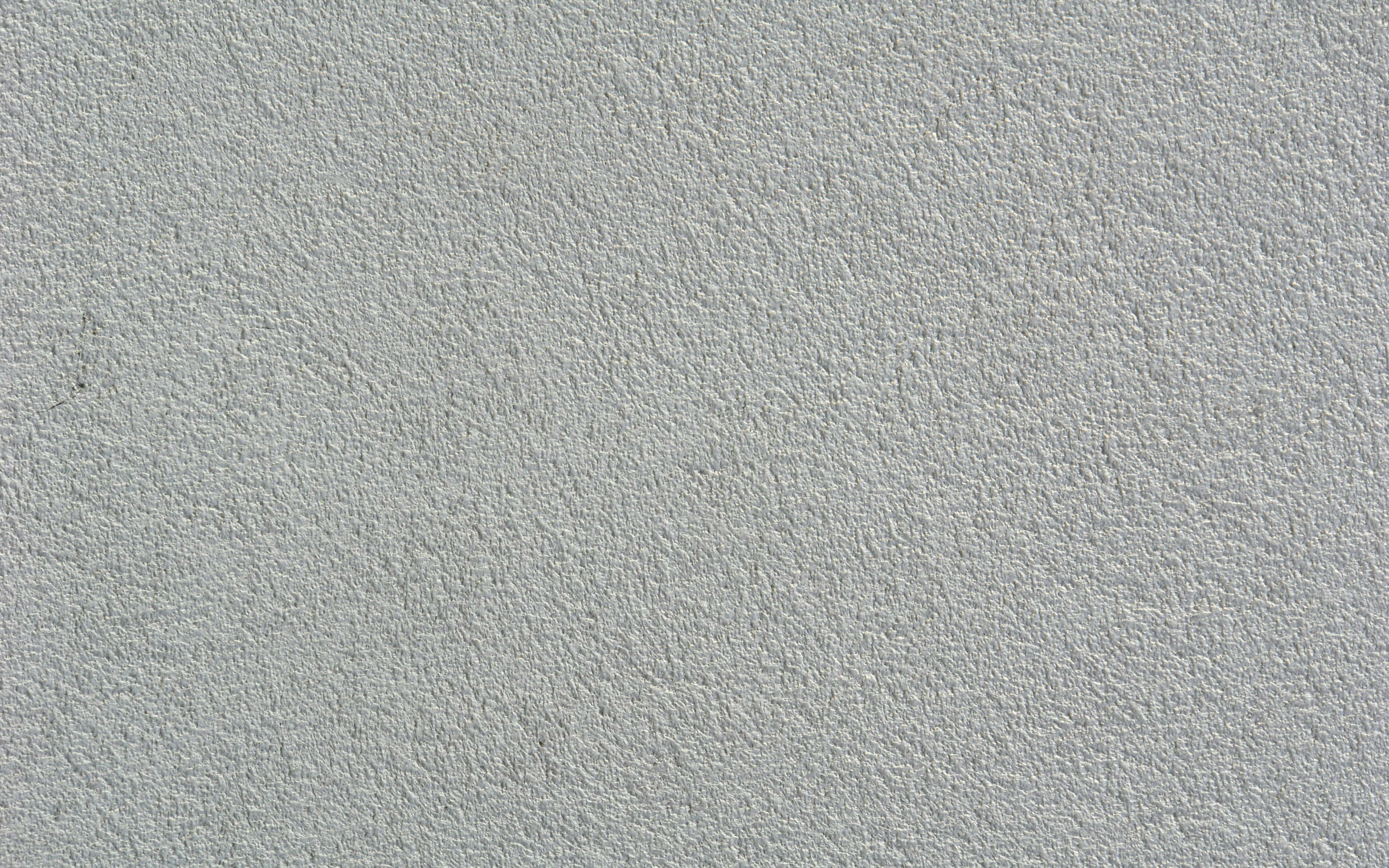 White Texture 桌布 壁紙 — 淺灰色平滑紋理牆面特寫，帶有細微顆粒和小瑕疵。