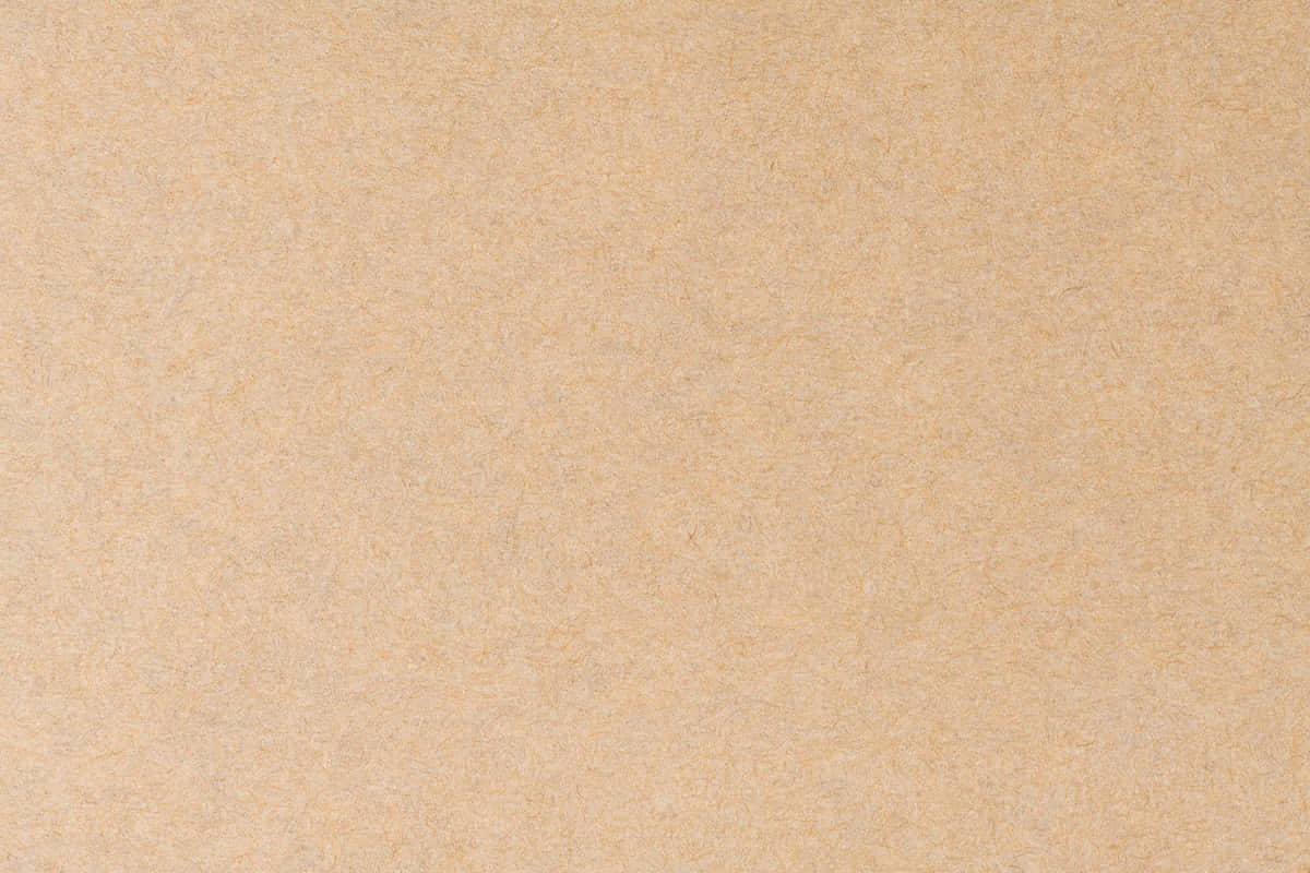 Brown Texture 桌布 壁紙 — 淺褐色光滑紙張表面的特寫，帶有細微纖維紋理和均勻光線。