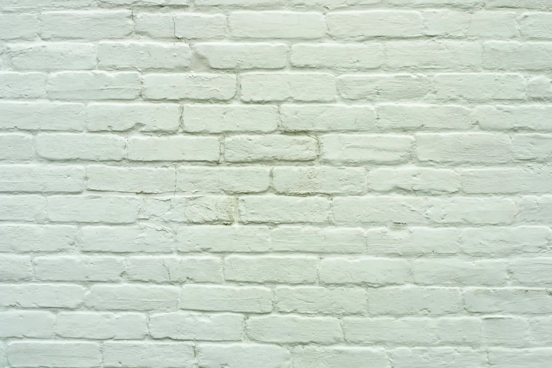 White Brick Wall 桌布 壁紙 — 清潔白色油漆磚牆的特寫，顯示出有紋理的砂漿線條和細微瑕疵。