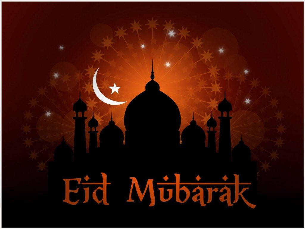 Eid Mubarak 桌布 壁紙 — 清真寺的剪影，帶有新月和星星，映襯著發光的橙色日落天空，並有「Eid Mubarak」文字。