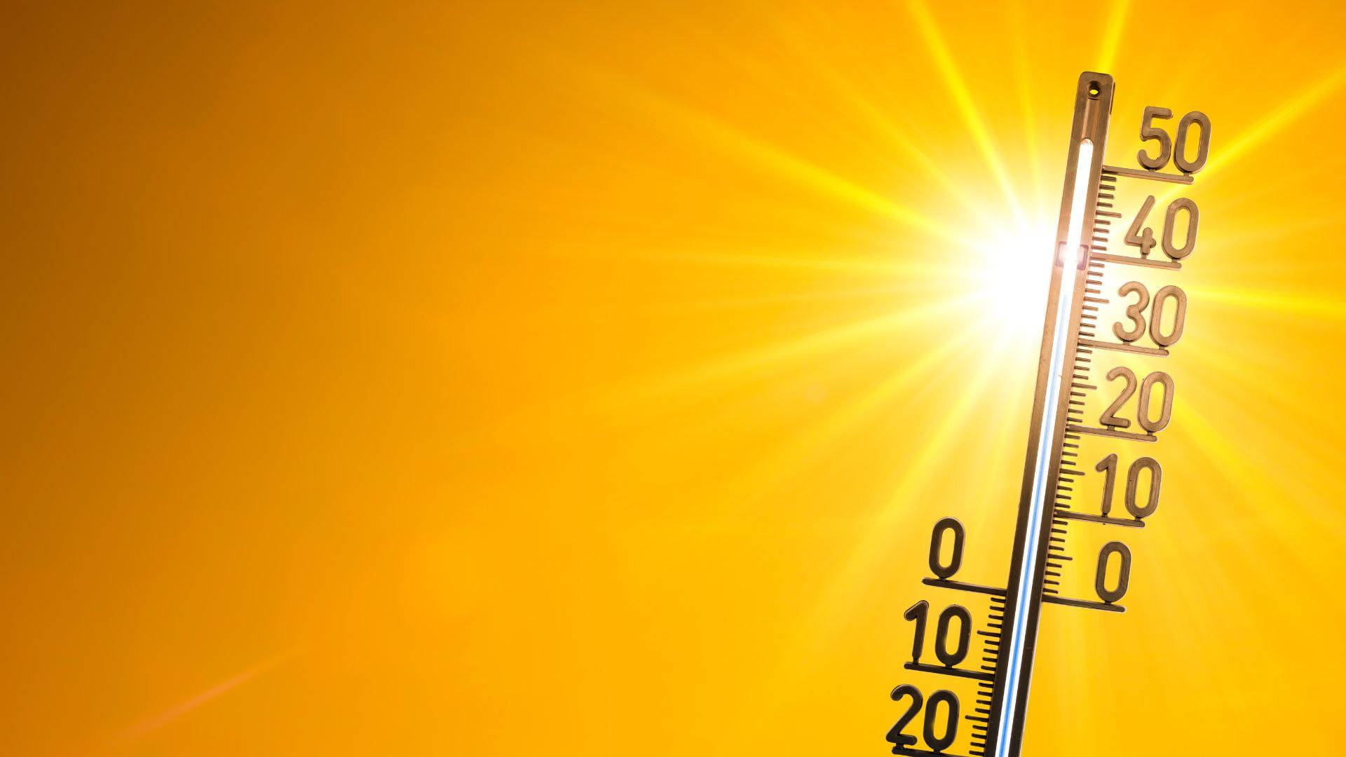 太陽 桌布 壁紙 — 溫度計在鮮黃色的放射狀陽光背景下顯示接近50度。